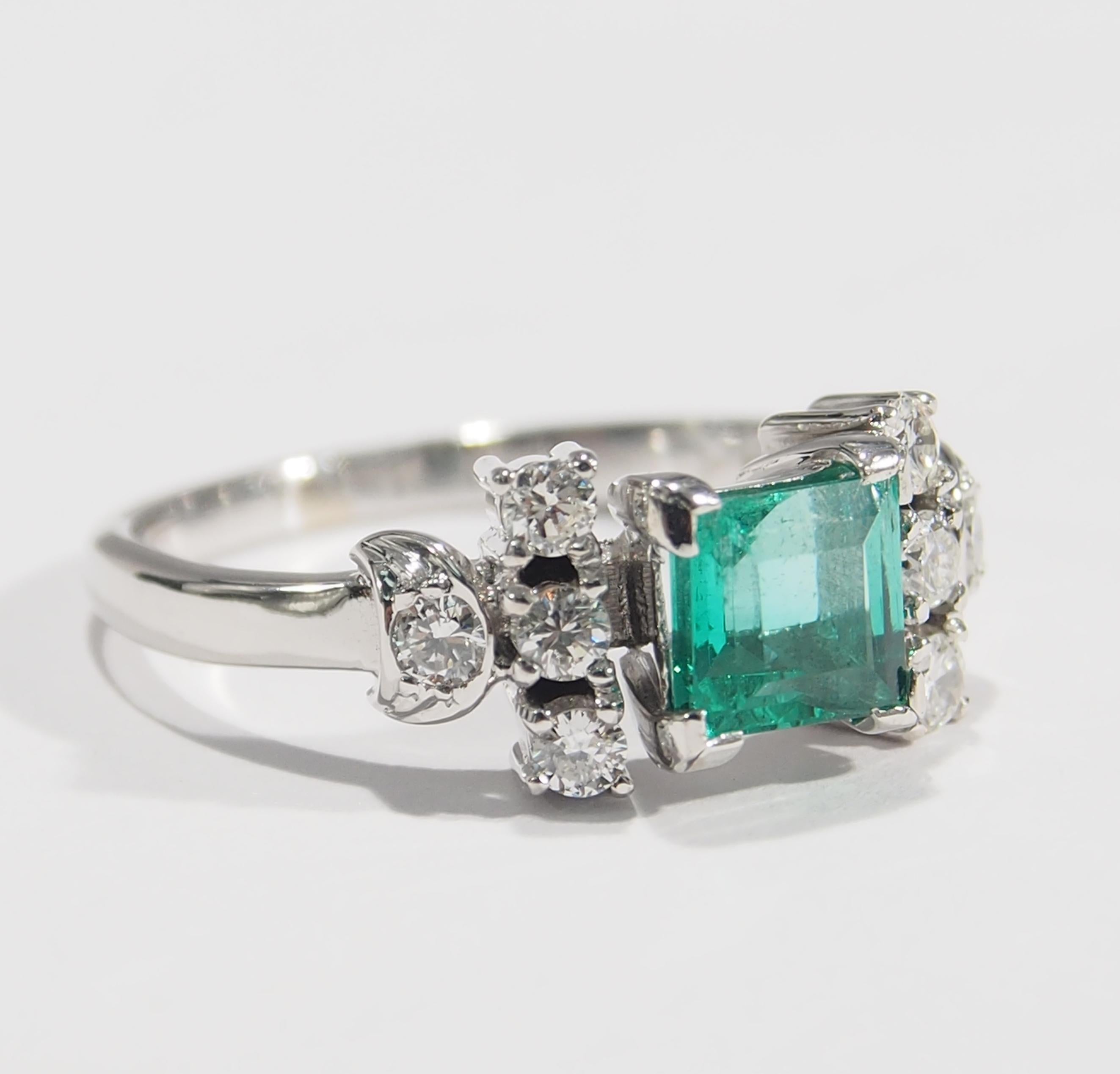 This is a classic 18K White Gold Emerald and Diamond Ring. The Ring is designed with a Square Emerald, approximately 0.80ct. framed by a total of (8) Round Brilliant Cut Diamonds, approximately 0.40ctw, G-H in Color, VS in Clarity on it's sides. The