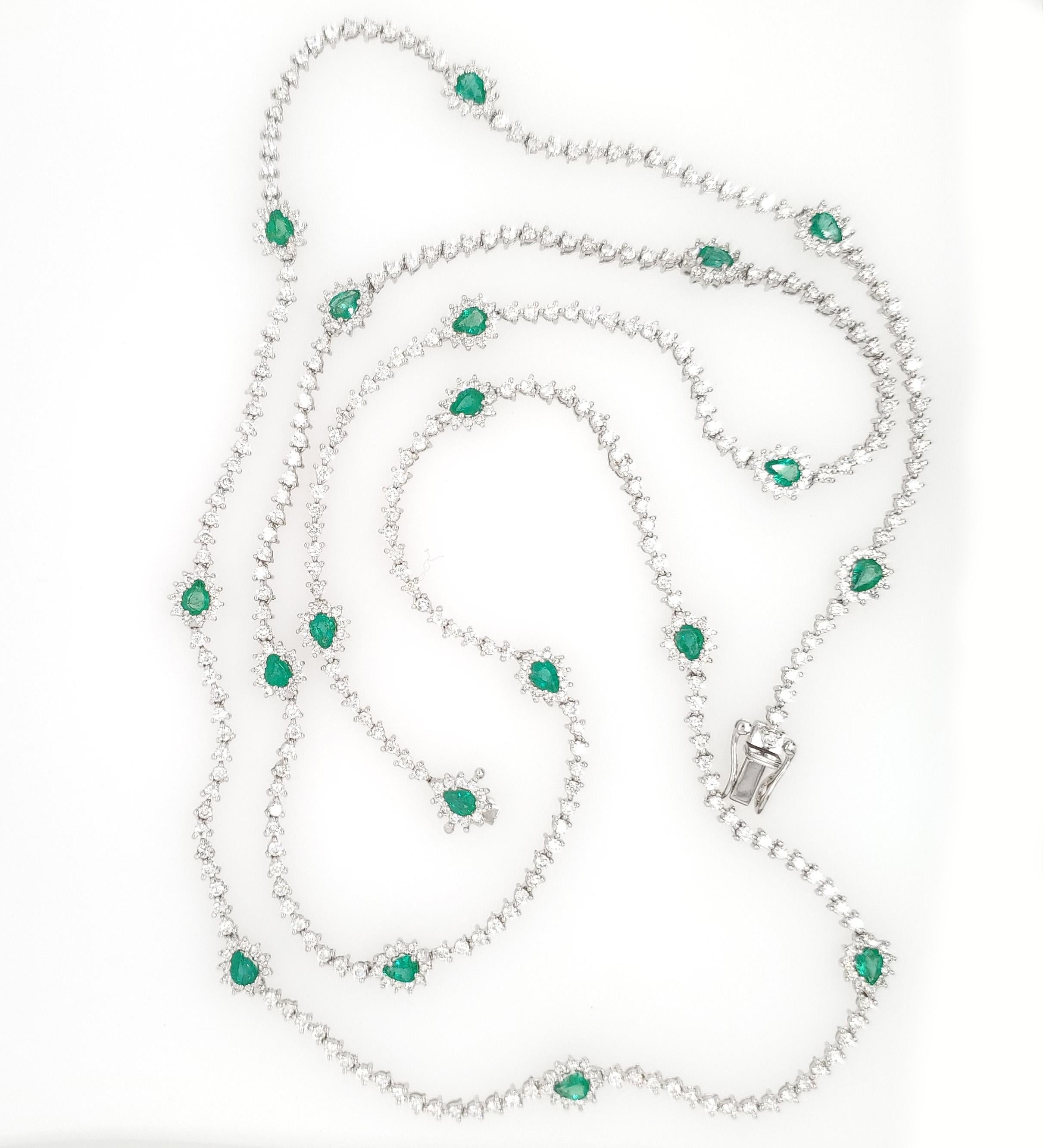 This is a stunning Tennis Necklace containing 497 Round Brilliant Cut Diamonds, approximately 6.58ctw, G-H in Color, VS-SI in Clarity that is accented with 19 Pear Shape Emeralds approximately 2.66ctw. This sparkling Necklace is 32 inches in length