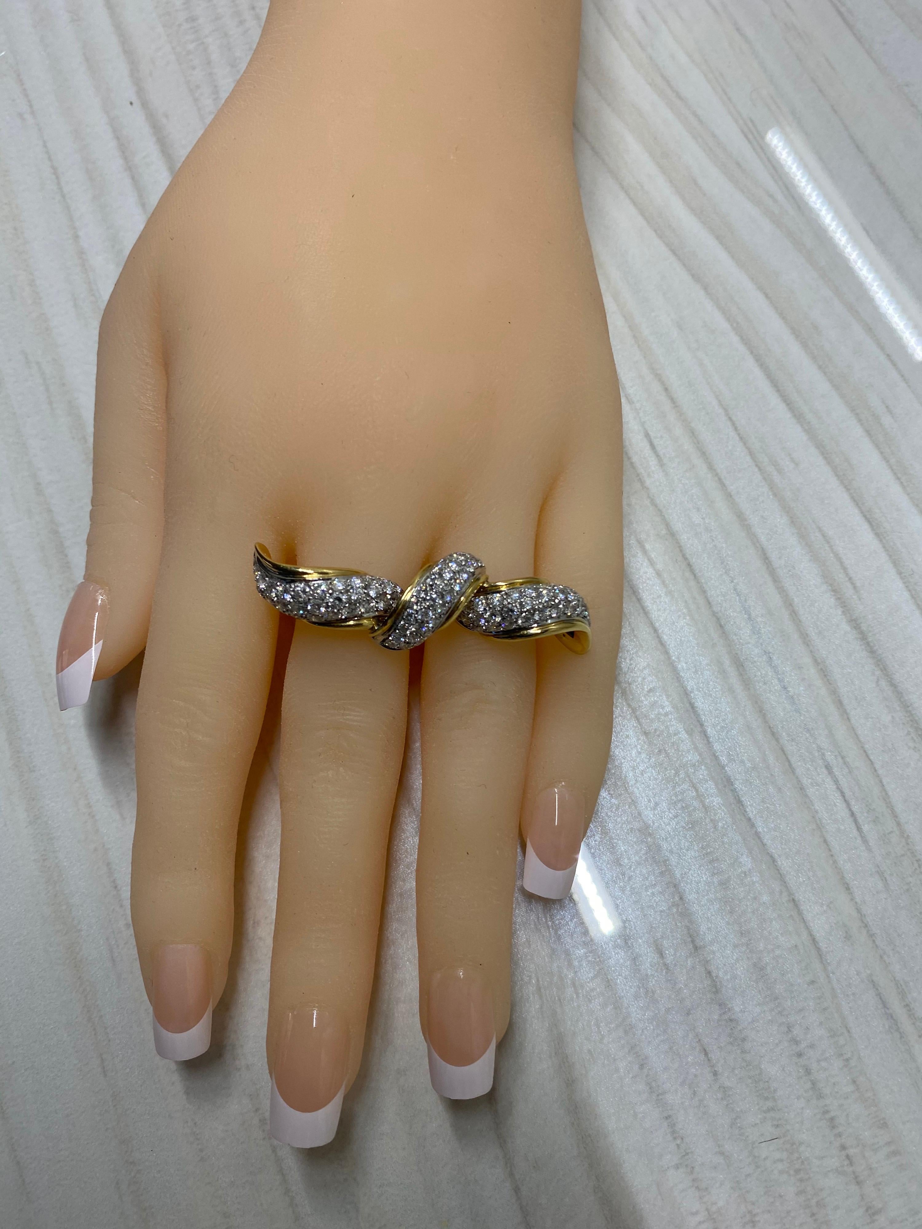 It doesn’t get more glamorous! Unique, blazing with approximately 3.75-4 carat of brilliant cut white VS diamonds set in 18k white gold bordered in 18k polished yellow gold. Diamond bow is estate, Custom modern double two tone shanks.
This two