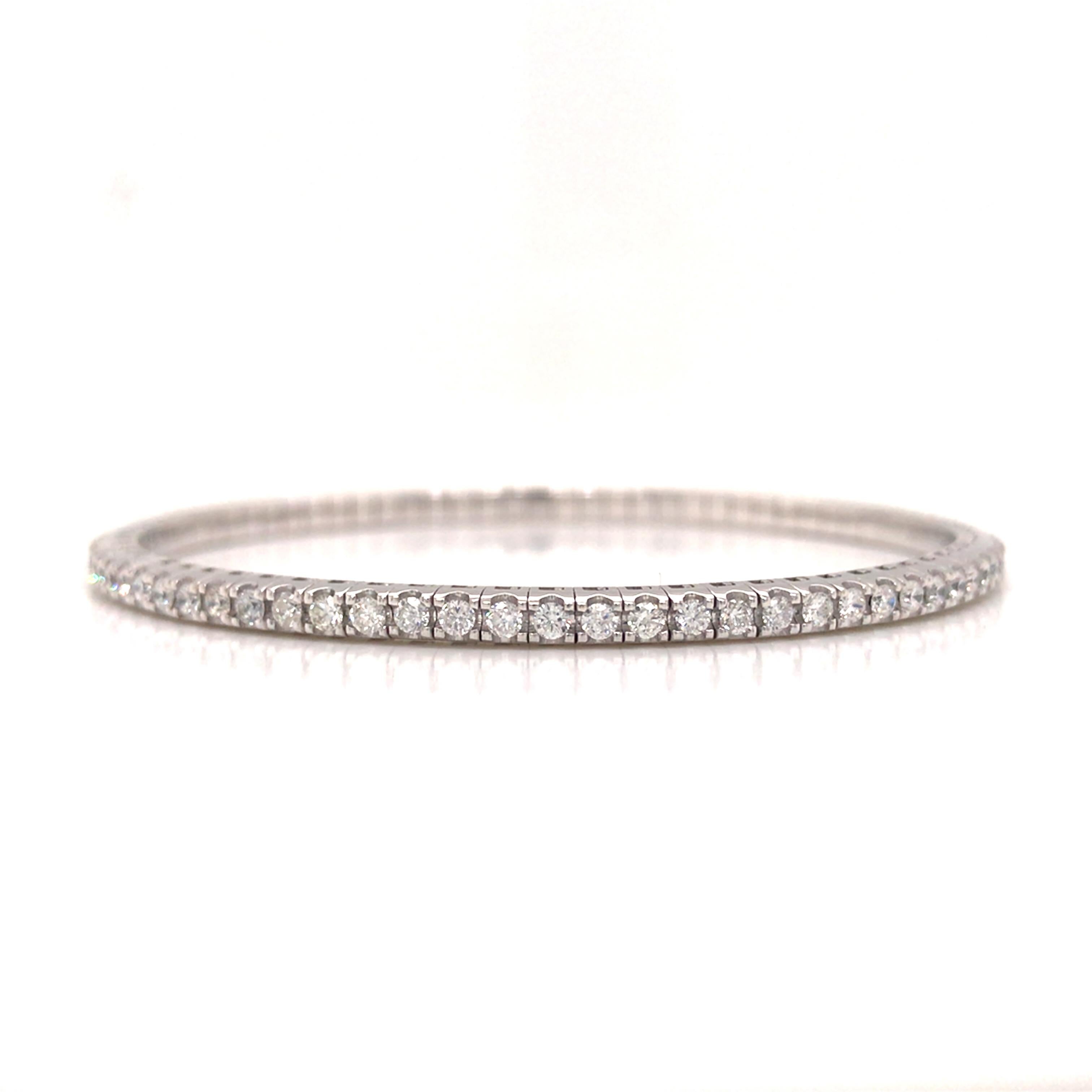 Diamond Flexible Stretchable Bangle in 18K White Gold. (78) Round Brilliant Cut Diamonds weighing 2.10 carat total weight, G-H in color and VS-SI in clarity are expertly set. The Bracelet measures 6 1/2 inch inner circumference and 1/8 inch in
