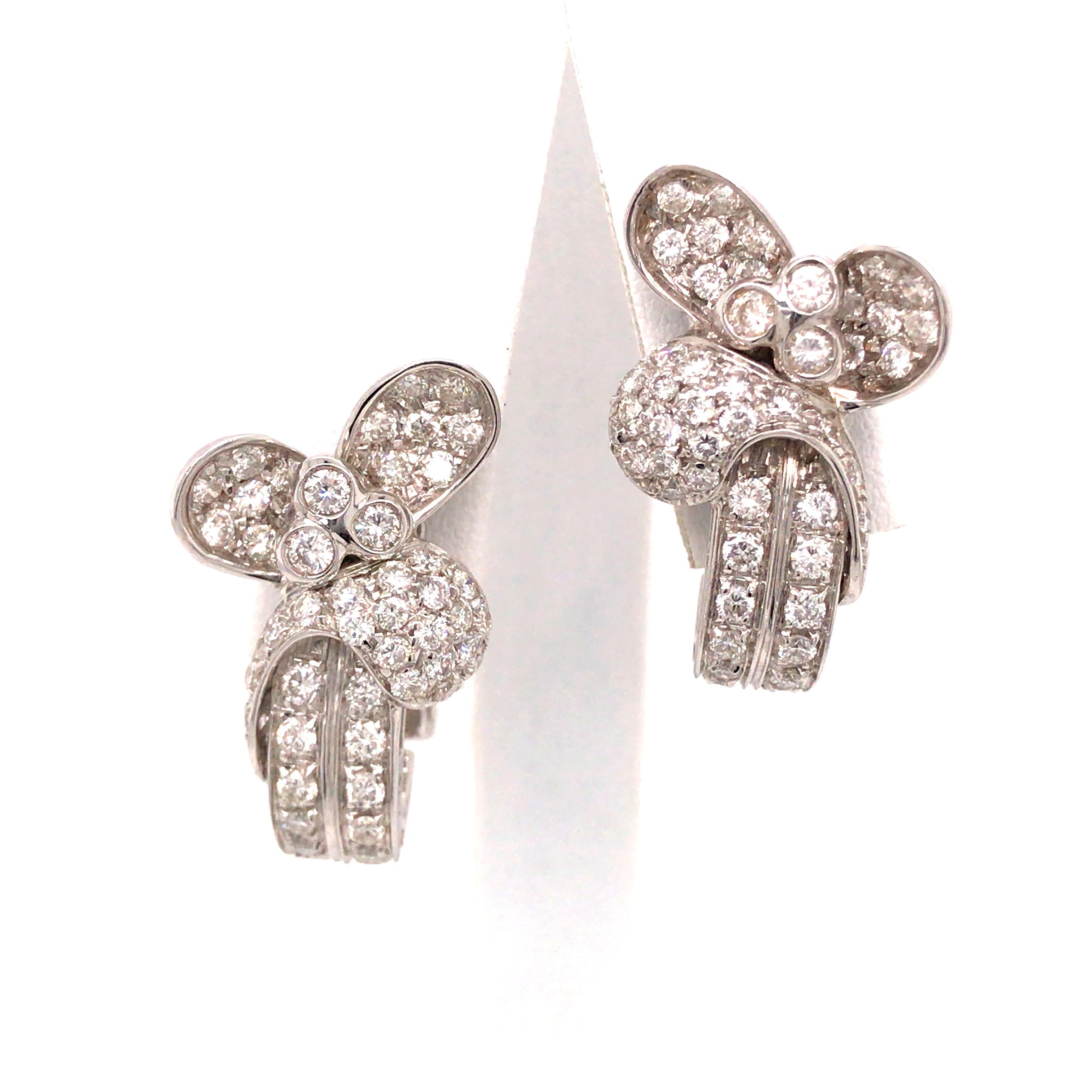 Diamond Flower Cluster Earring in 18K White Gold.  Round Brilliant Cut Diamonds weighing 3.16 carat total weight, G-H in color and VS in clarity are expertly set.  The Earrings measure 1 inch in length and 5/8 inch in width.  16.95 grams. Omega Back.