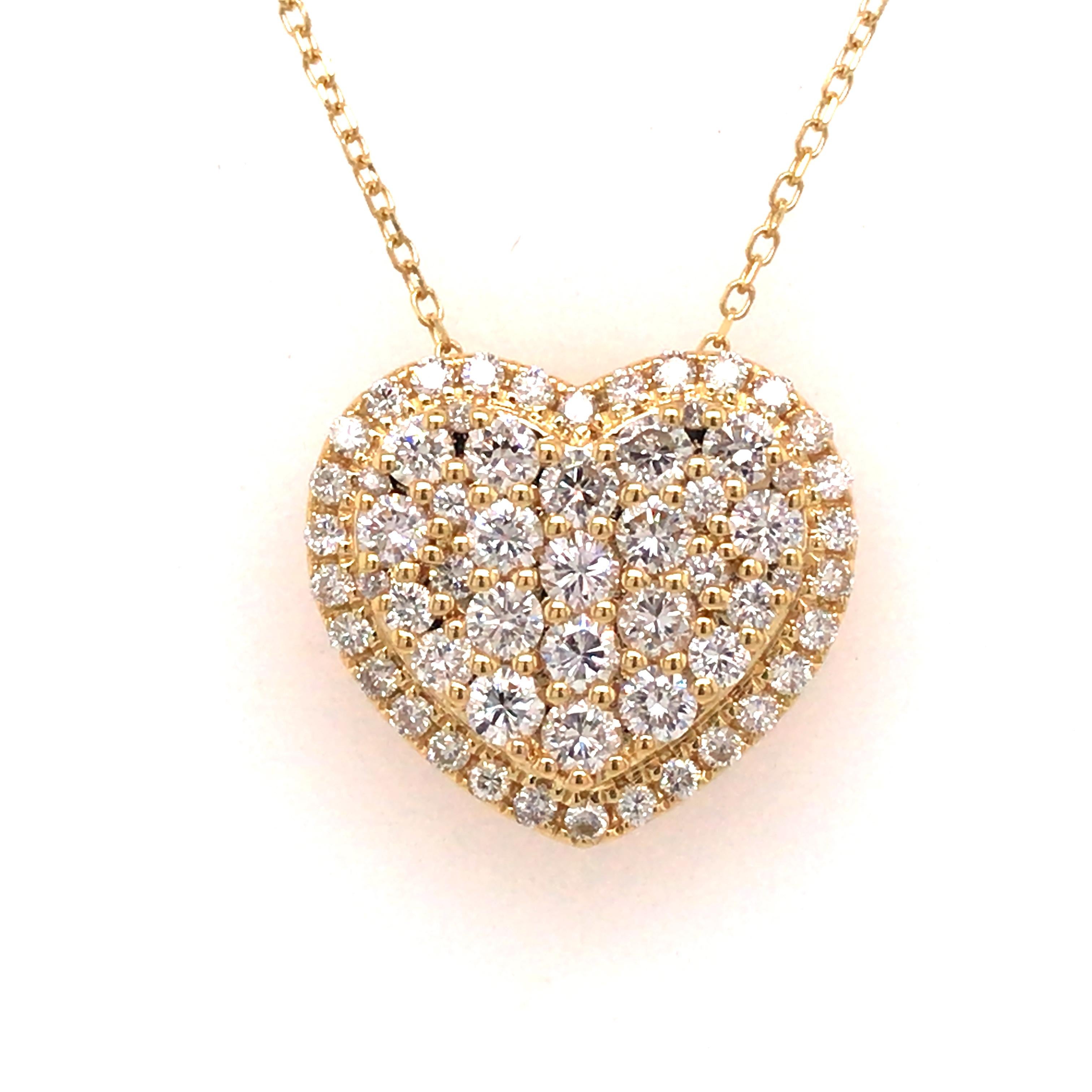 Diamond Heart Cluster Pendant in 18K Yellow Gold. (60) Round Brilliant Cut Diamonds weighing 1.0 carat total weight, G-H in color and VS in clarity are expertly set. The Necklace measures 18 inch in length.