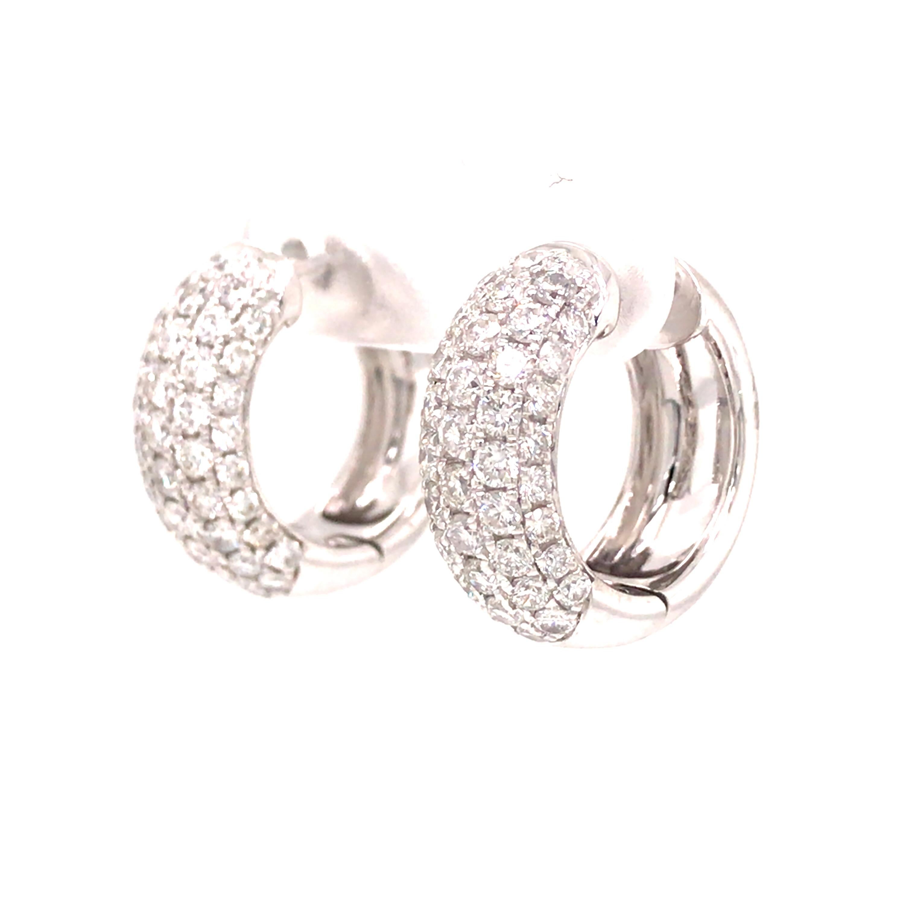 Diamond Pave Huggie Earrings in 18K White Gold.  (88) Round Brilliant Cut Diamonds weighing 2.0 carat total weight, G-H in color and VS-SI in clarity are expertly set.  The Earrings measure 11/16 inch in length and 1/4 inch in width.  10.41 grams.