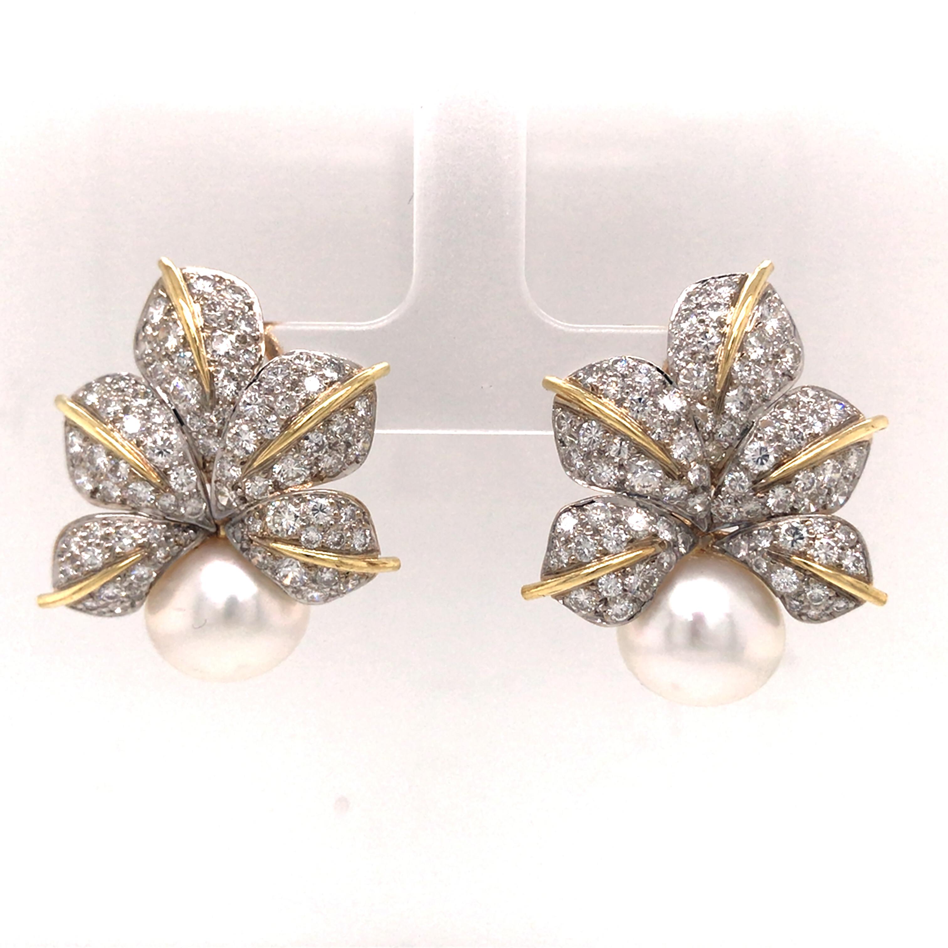 Diamond Pave Leaf and Pearl Earrings in 18K Two-Tone Gold.  Round Brilliant Cut Diamonds weighing 5.43 carat total weight, G-H in color and VS in clarity are expertly set with (2) 12mm White Round Pearls.  The Earrings measure 1 1/4 inch in length