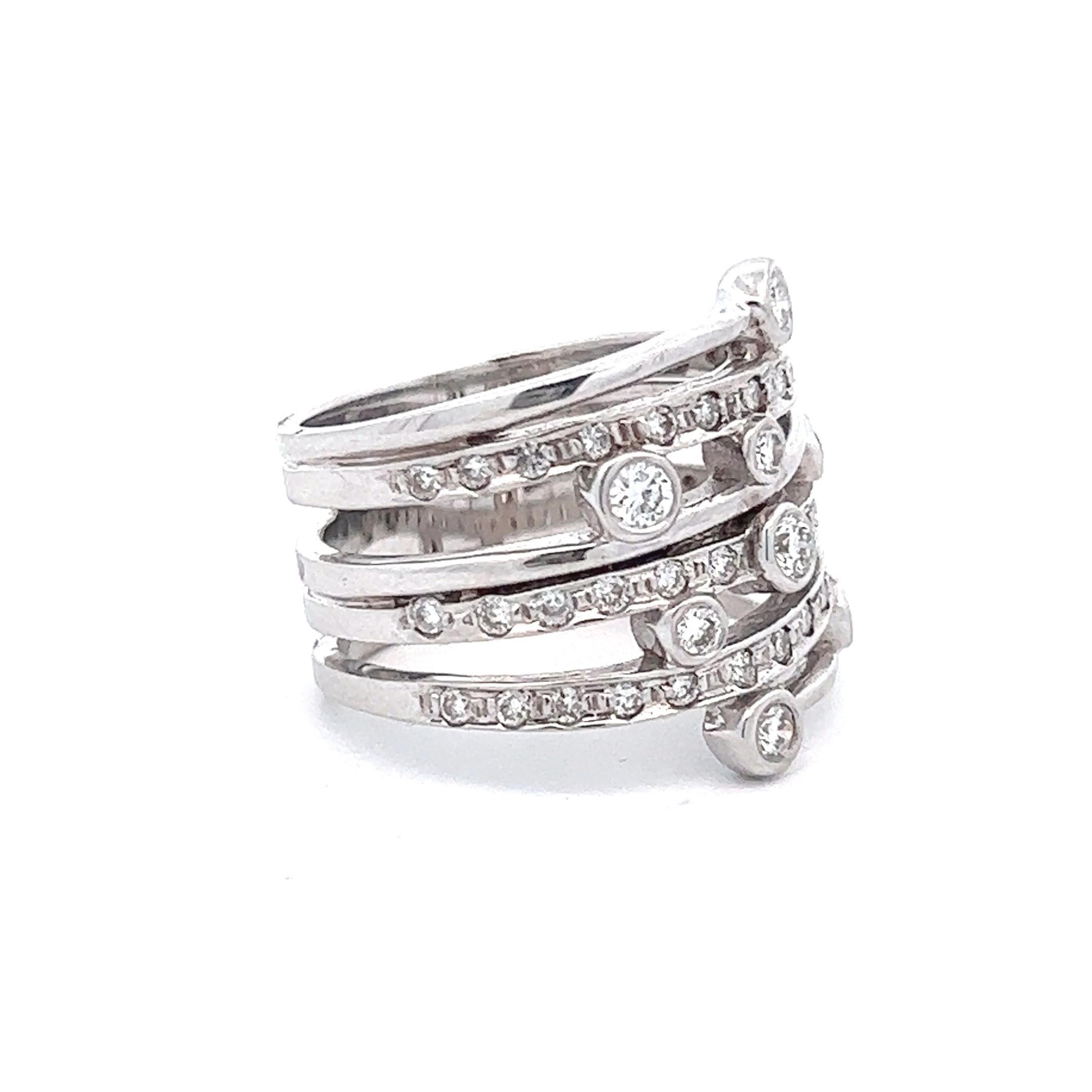 A lovely 18k white gold diamond ring stamped Andy G. The ring features approximately 0.6 ctw round brilliant diamonds asymmetrically channel set along it's bands. The ring is currently a size 7 but can be resized. 