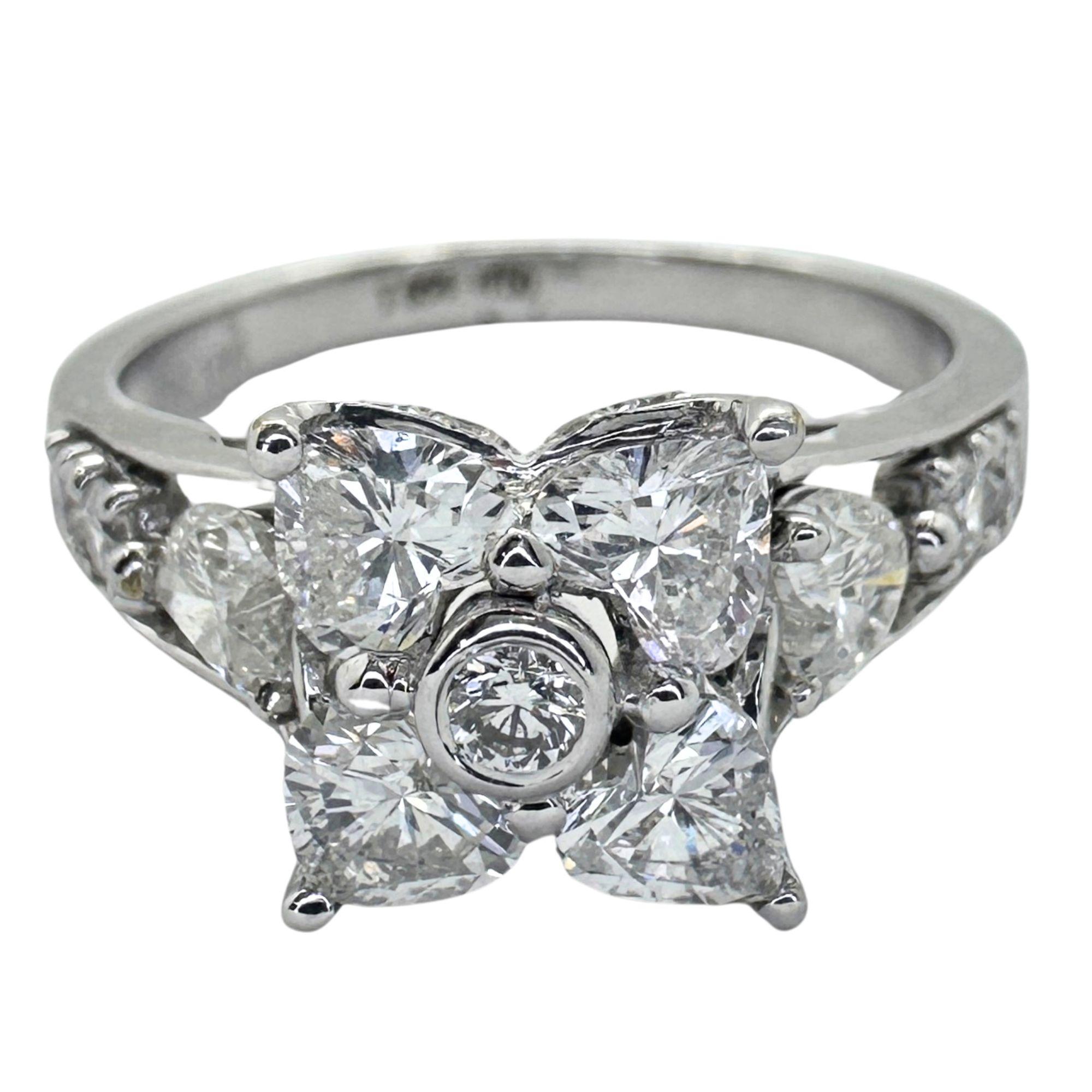 Crafted with precision and expertise, our 18k Diamond Ring features a beautiful floral design in the center and heart-shaped diamonds. Made with 18k white gold, this ring showcases stunning craftsmanship and elegance. With a weight of 4.22 grams and