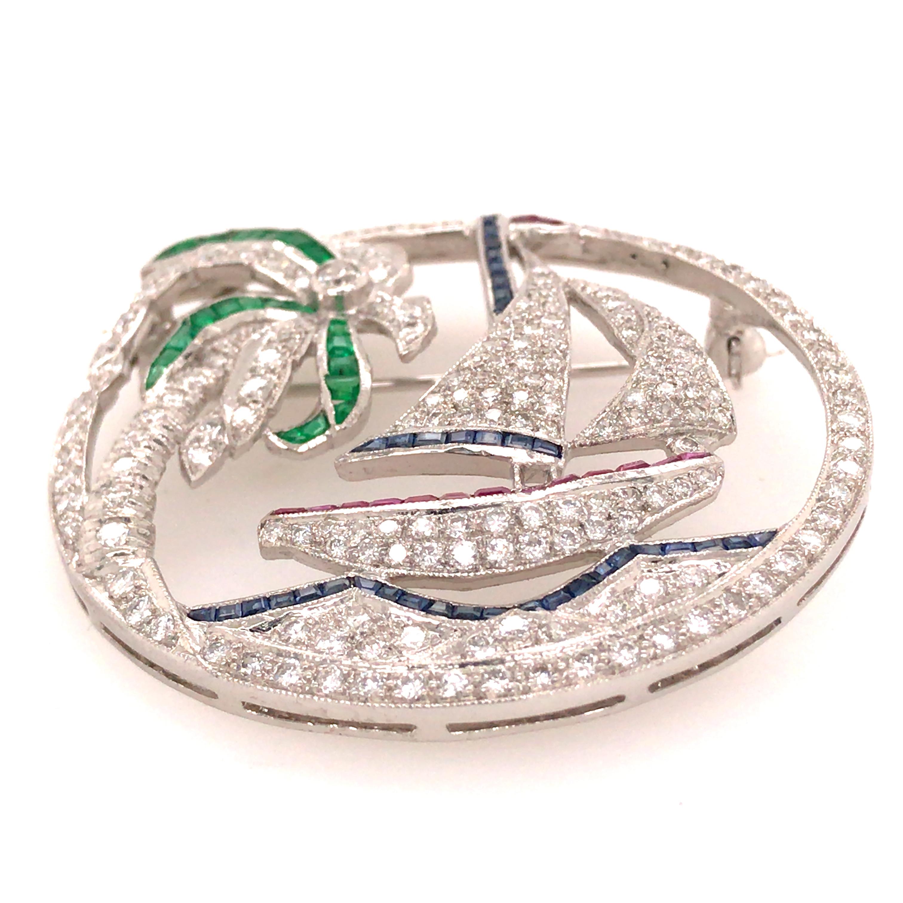 Diamond, Ruby, Sapphire and Emerald Sailboat Pin in 18K White Gold.   Round Brilliant Cut Diamonds weighing 2.2ctw, G-H in color and VS in clarity, (15) Ruby Gemstones weighing .12ct, (40) Sapphire Gemstones weighing .24ct and (24) Emerald Gemstones