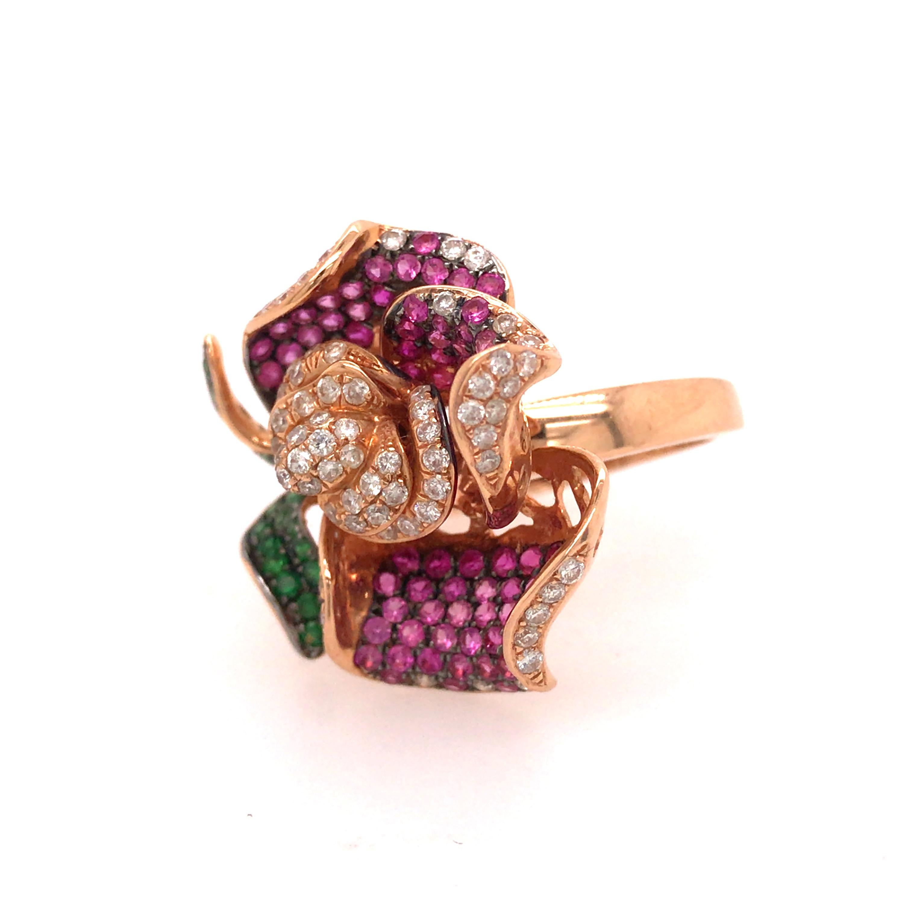 Diamond, Sapphire and Tsavorite Flower Ring in 18K Rose Gold.  (72) Round Brilliant Cut Diamonds weighing 0.75 carat total weight, G-H in color and VS in clarity, (92) Pink Sapphires weighing 1.8 carat total weight and (21) Tsavorite Stones weighing