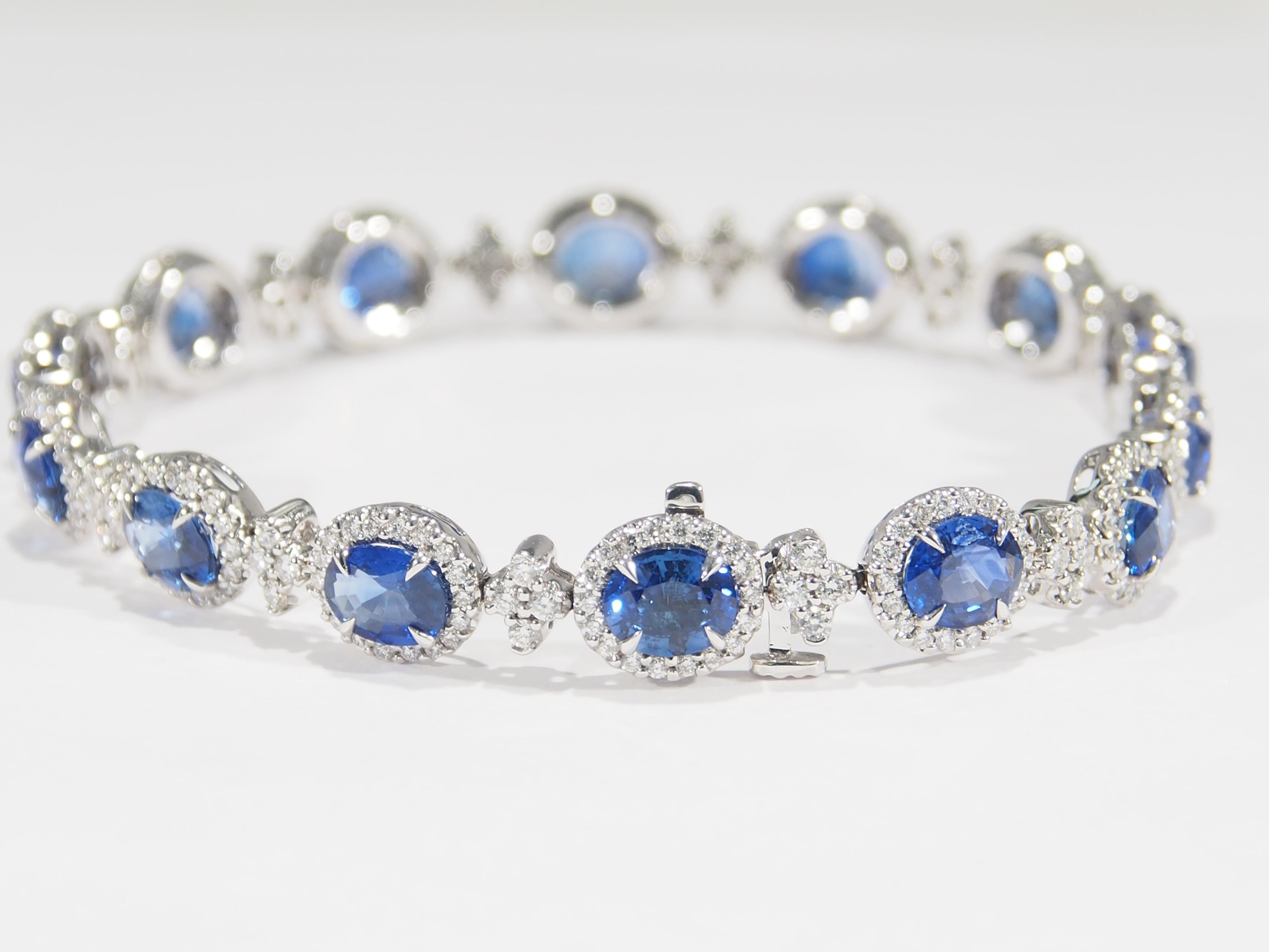 A gorgeous 18K white gold Diamond and Sapphire bracelet. 14 Oval Sapphires,10.49 total weight, are set with a diamond halo surrounding each Sapphire and diamond clusters between. Expertly set with 308 Round Brilliant Cut Diamonds G-H in color VS-SI