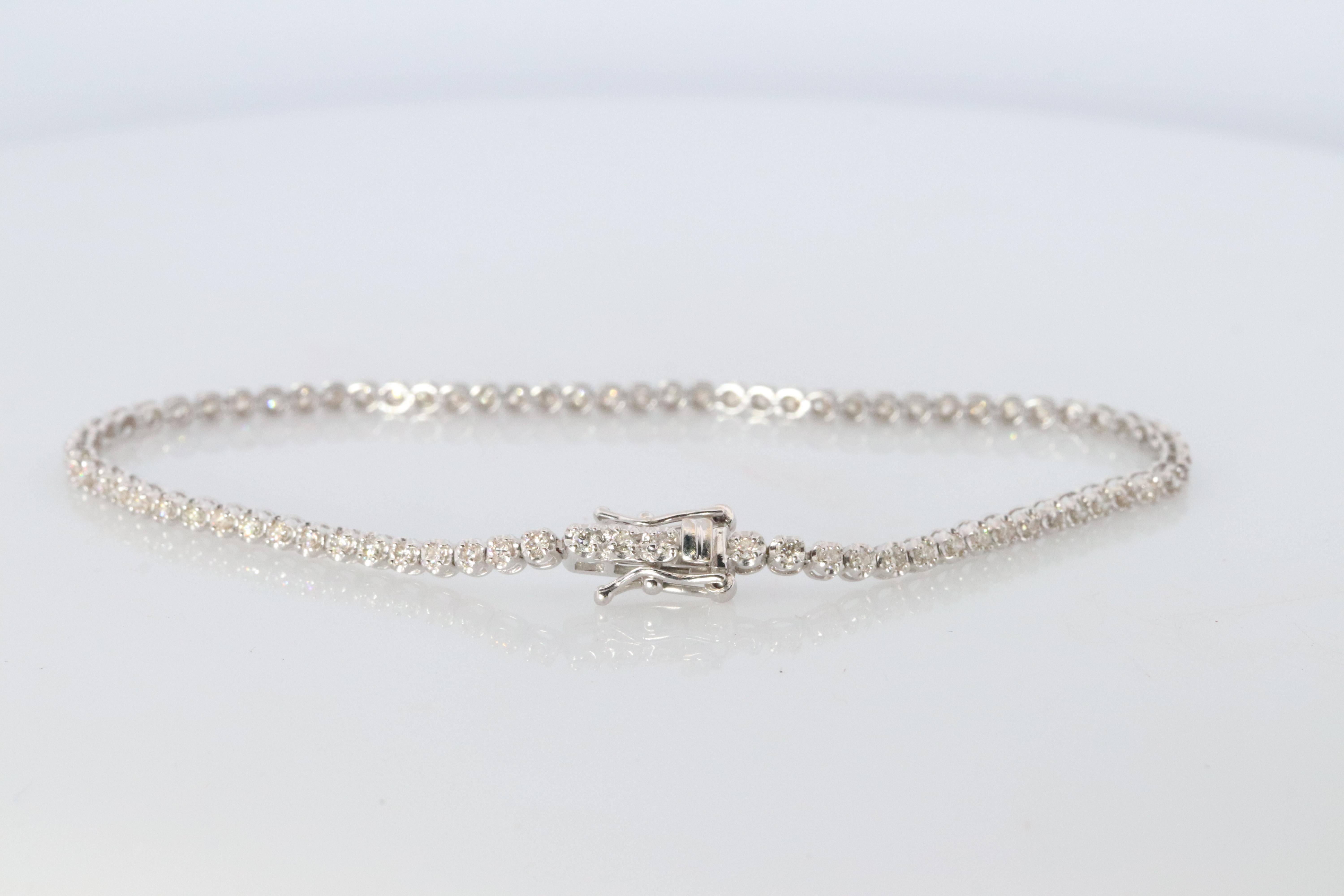 Diamond Tennis Bracelet.

18k White Gold.

Details:
7in length
4.2grams total weight
1ctw Total SI Clarity G color
2.5mm wide