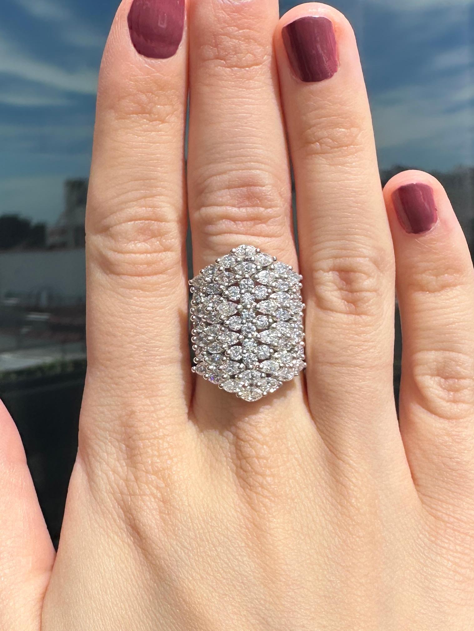 Indulge in luxury with this exquisite 18k Diamond Wide Band Ring. Crafted from 18k white gold, this ring boasts 4.10 carats of sparkling diamonds set on a 25.92mm wide band. With a ring size of 6.75 and a weight of 12.2 grams, this ring is sure to