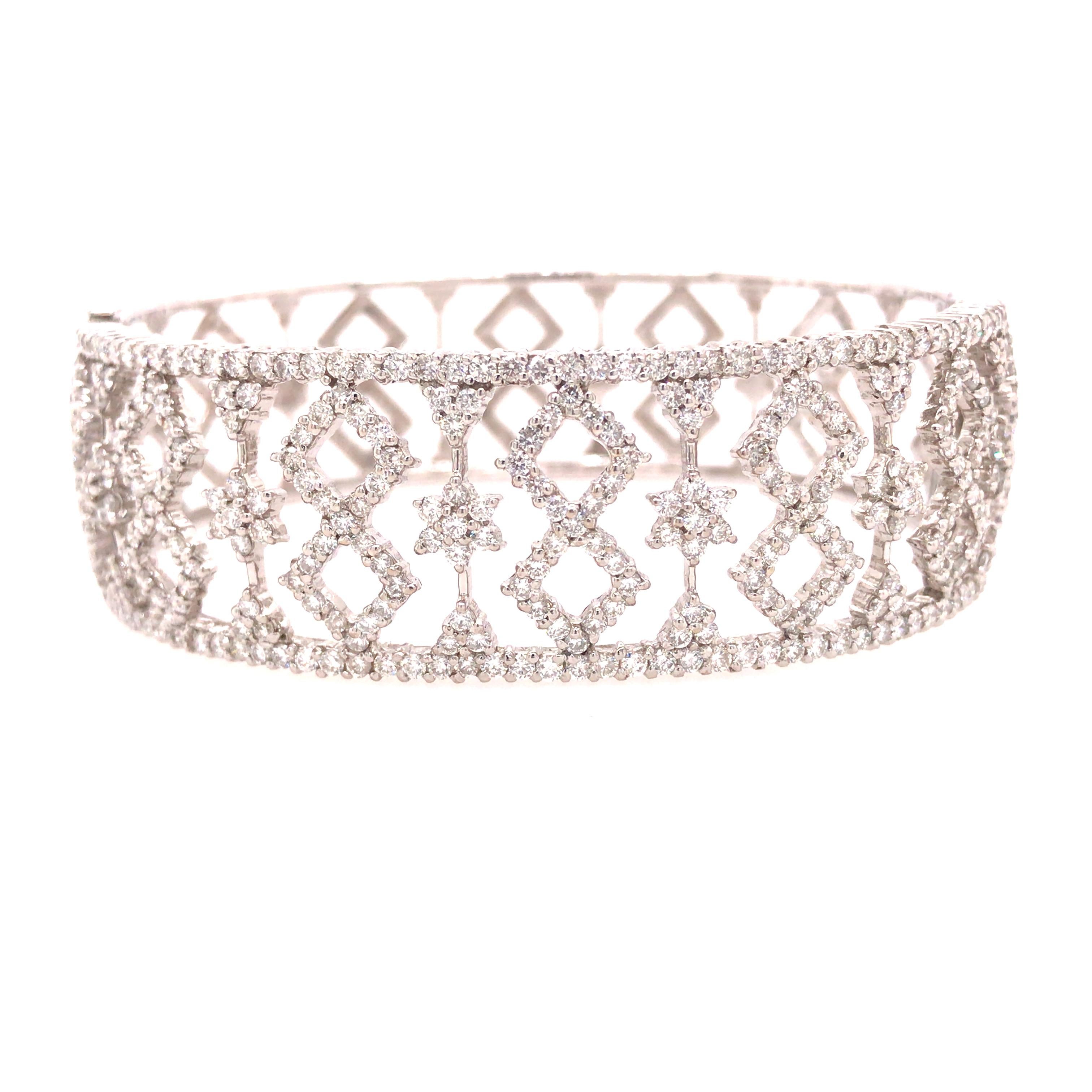 Diamond Wide Bangle Cuff in 18K White Gold. Round Brilliant Cut Diamonds weighing 6.70 carat total weight, G-H in color and VS-SI in clarity are expertly set. The Bangle measures 7 inch inner circumference and 3/4 inch in width. 37.79 grams.