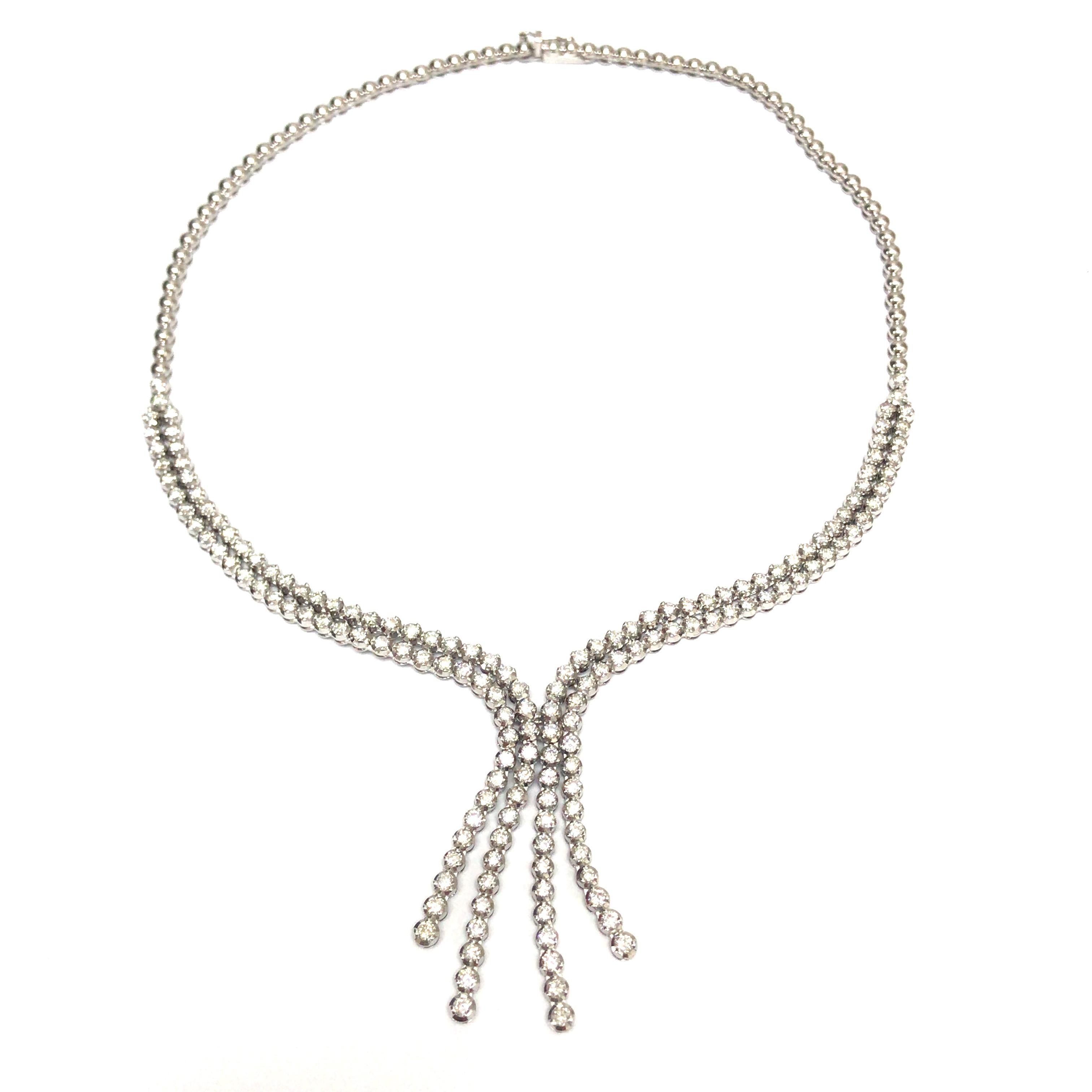 Diamond Y Necklace in 18K White Gold.  Round Brilliant Cut Diamonds weighing 10.18 carat total weight G-H in color and VS in clarity are expertly set.  The Necklace measures 15 inches with 1 3/4 inch lariat. 44.79 grams.