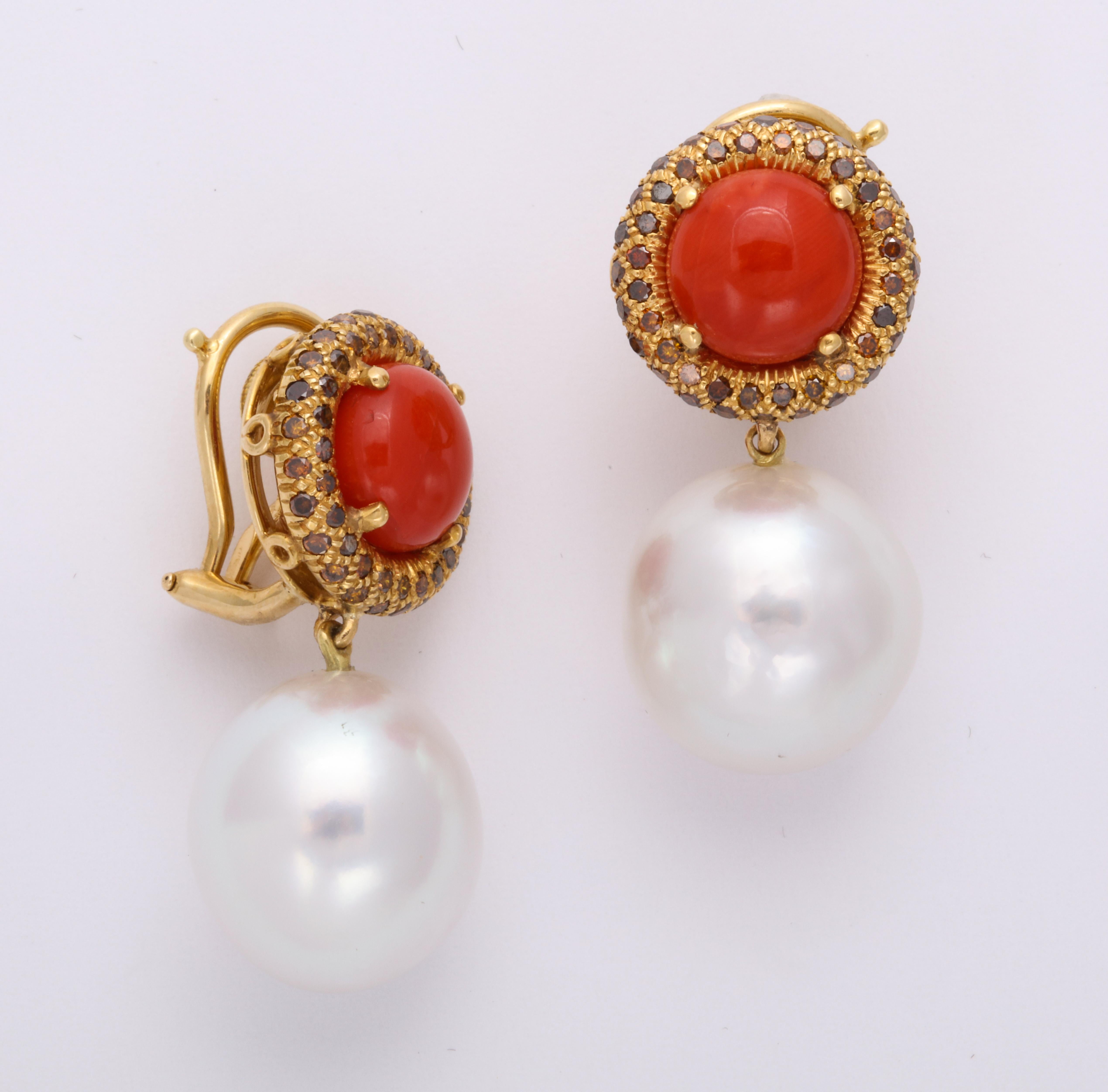 A classic Donna Vock design, this clip-on earring features high quality natural color (not dyed) red coral surrounded by 1.75 carats of natural color brown diamonds in a pretty shade of cognac, all pave set in 18K yellow gold.  The earring has a