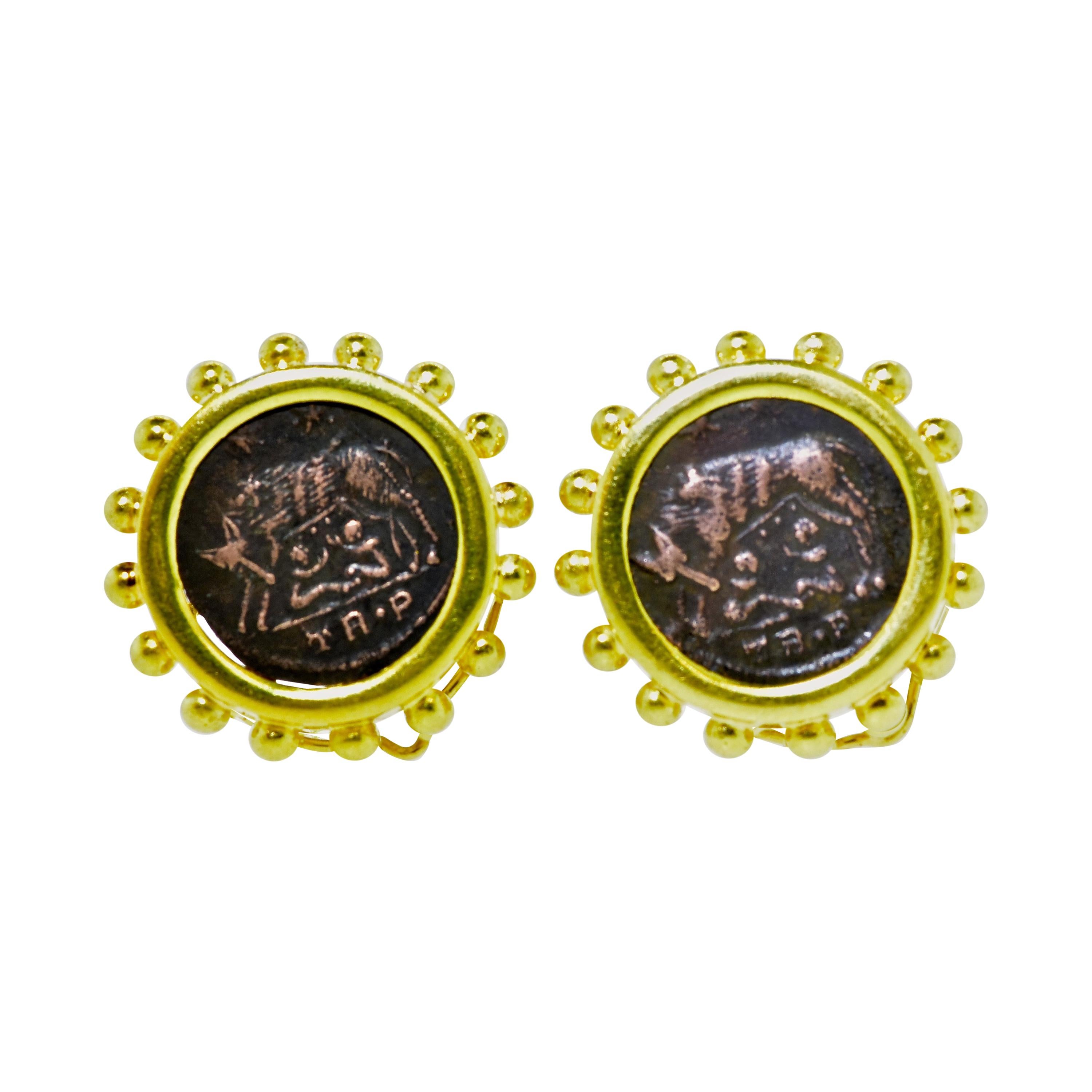 18K yellow gold earrings centering ancient coins depicting the she-wolf, Capitoline, suckling the mythical twin founders of Rome, Romulus and Remus.  These contemporary on the ear earrings are just under 1 inch in diameter.  The post is a flip up or
