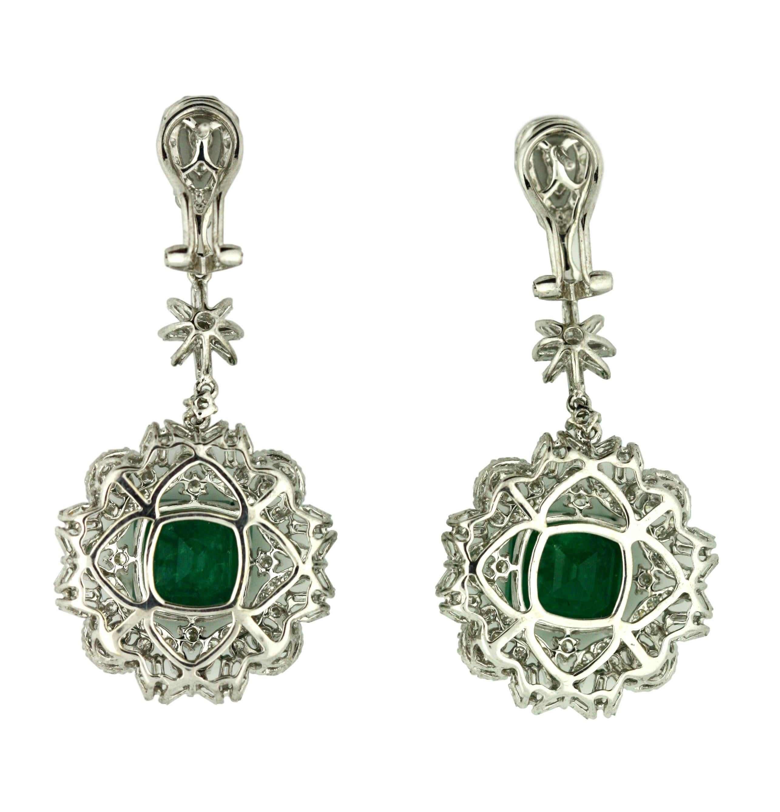 18K Emerald and Diamond Earrings 
Set with two octagonal step-cut emeralds weighing approximately 8.28 carats, framed within a surround of and topped by two hundred thirty-six round diamonds weighing approximately 3.84 carats. 
Measuring 9.28 x 9.25