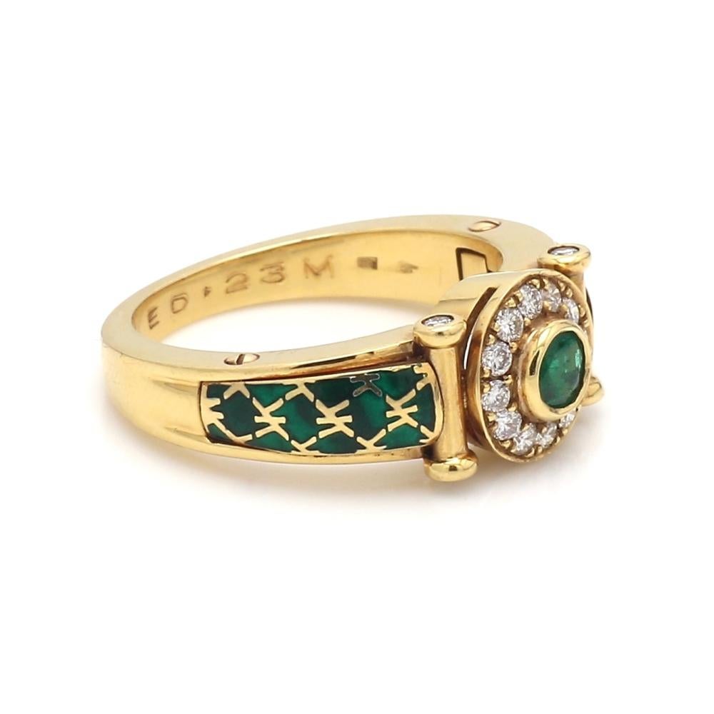 18K yellow gold, emerald, diamond, and green enamel ring. Center stone is one (1)  round brilliant cut emerald weighing approximately 0.23ct. Emerald is surrounded by sixteen (16) round brilliant cut diamonds weighing approximately 0.30ctw. Unknown