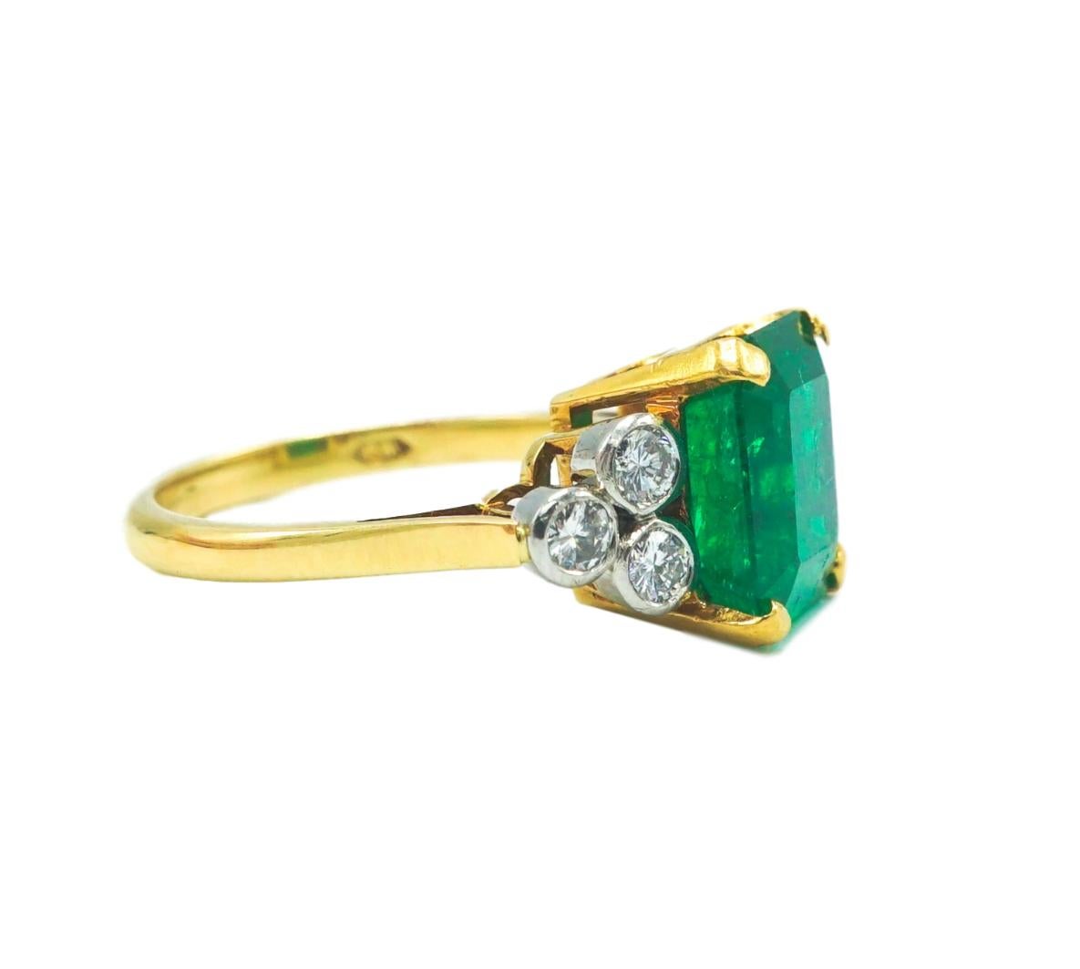 Emerald and Diamond Ring with AGl Report, Centering on rectangular emerald with diamond-set shoulders.
Emerald 4.8 cts  with certificate. 
Metal: 18k Yellow Gold
Diamonds: 6 round diamonds with approximate total weight of 0.36 carats

SKU#R-01415