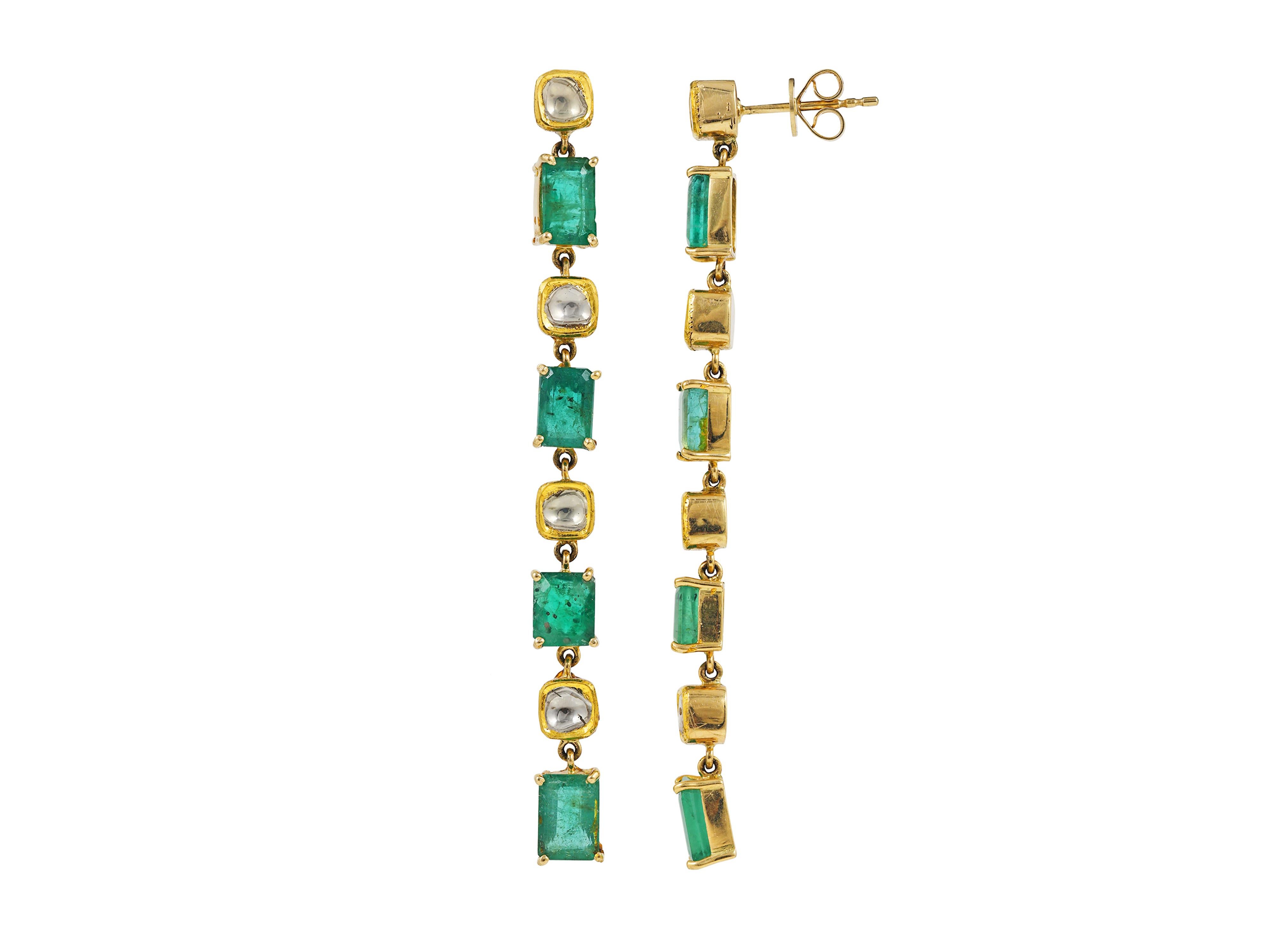 A pair of earrings set with octagon emeralds in 18K gold along with sliced uncut diamond polkis.

The earring base is done in 18K gold and emeralds are set with the help of prongs where as the uncut polkis are silver foiled at back and is set in