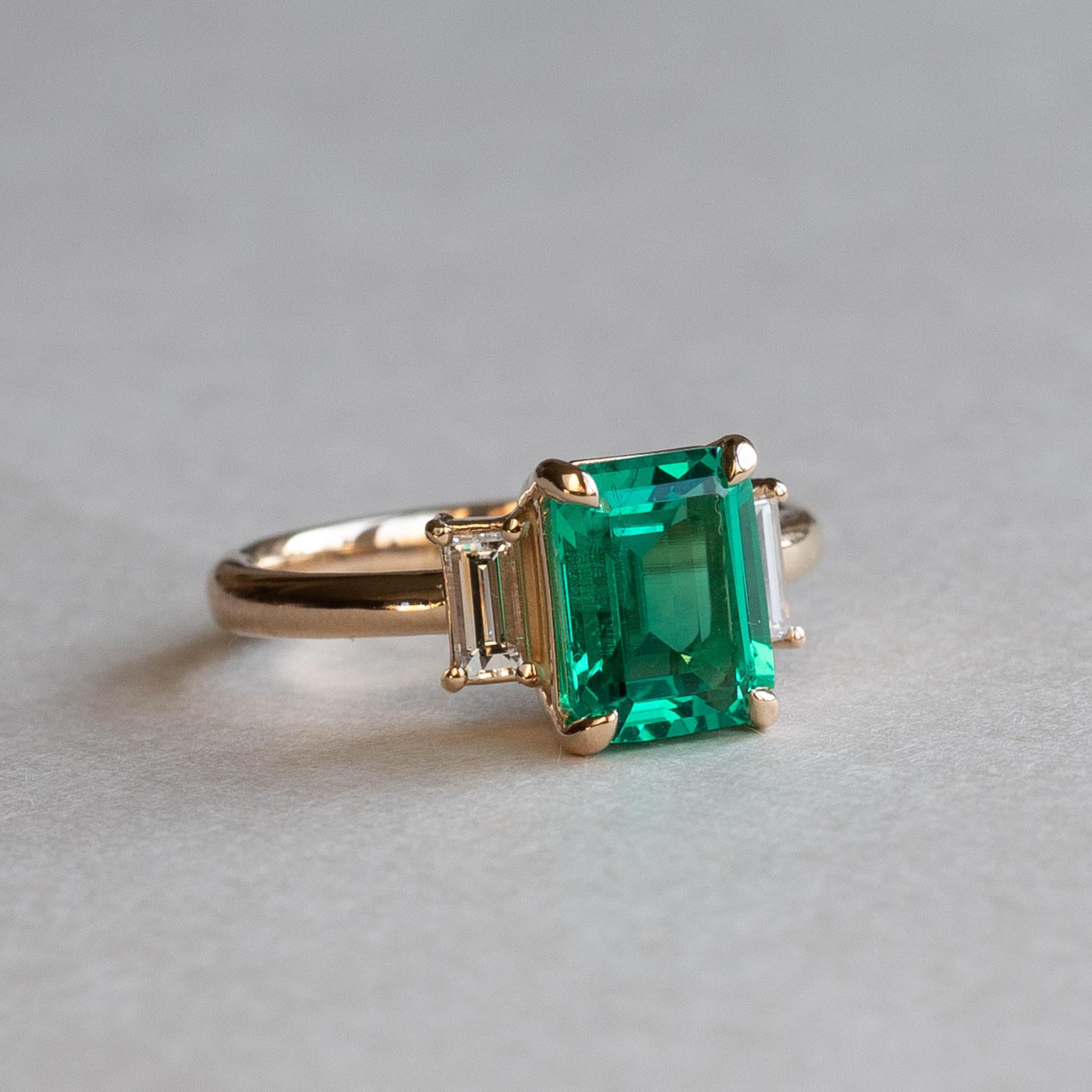 Emerald adorned with baguette diamonds
Stone: Lab Grown Emerald
Cut: Emerald/Step
Three stone ring
Stone Size: 8 x6 mm
Baguette Diamonds: Two 4.5 x 2 mm
Diamond Clarity: SI
Diamond Color: GHI
Diamond weight: 0.12 carat each
Total Diamond Weight: