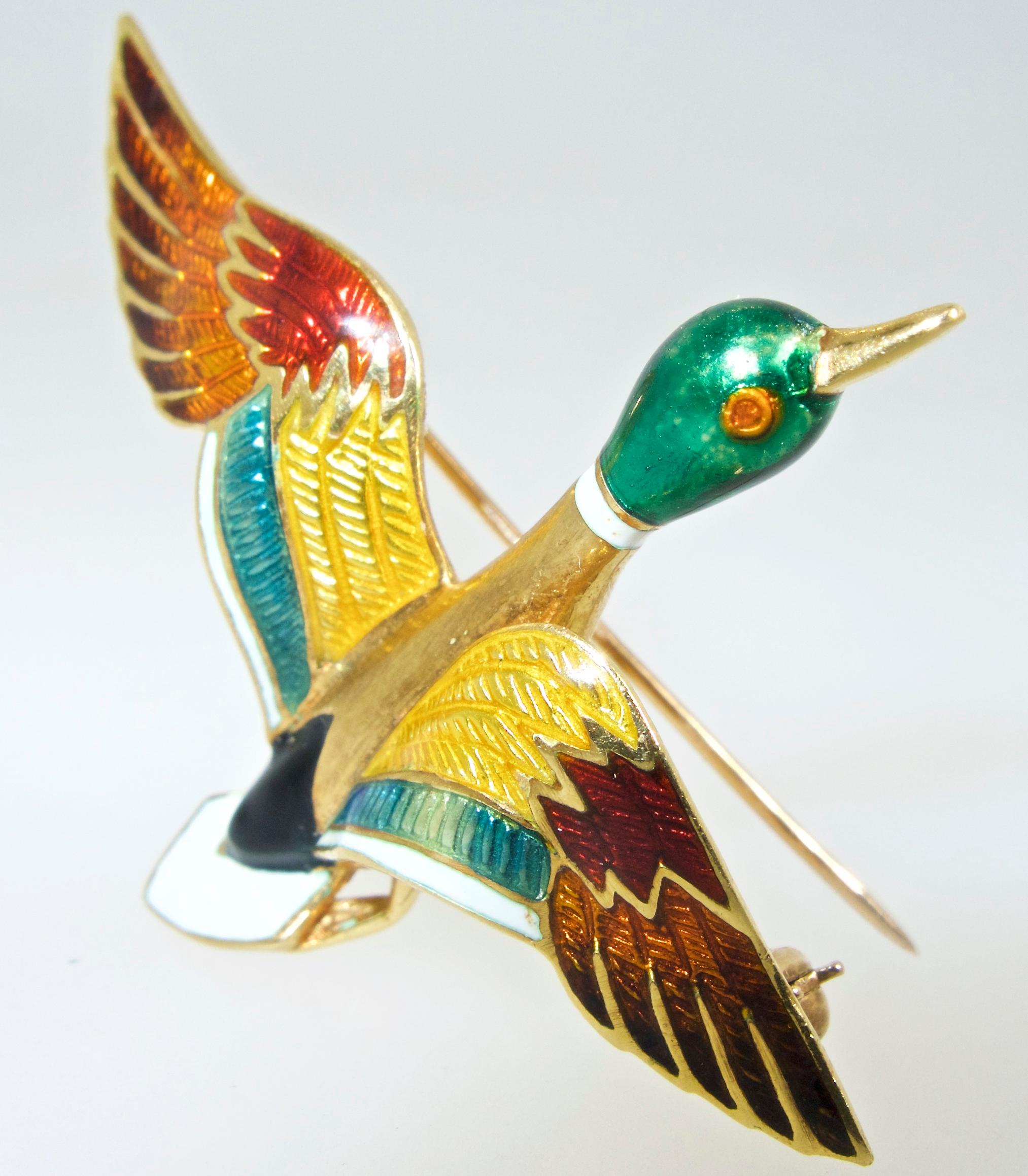 18K and weighing 7.8 grams, with 7 different colors of enamel, both guilloche and opaque, bringing our Mallard duck to life.  He is 2 inches long, and 1.75 inches wide.  In fine condition.