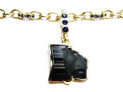 18k Enhancer, carved black tourmaline lions head, blue sapphire bail