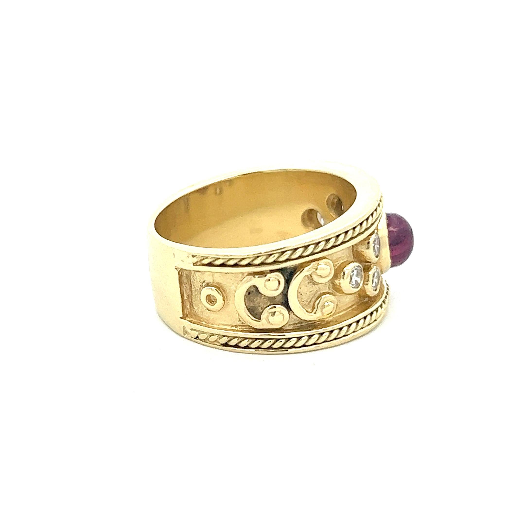 An incredible Etruscan-style ring presenting a cabochon ruby accented by six radiant round brilliant diamonds. The ruby weighs approximately 1.33 cts and the diamonds are approximately 0.34 ctw. The ring is a size 8 (sizeable) and is crafted of 18k