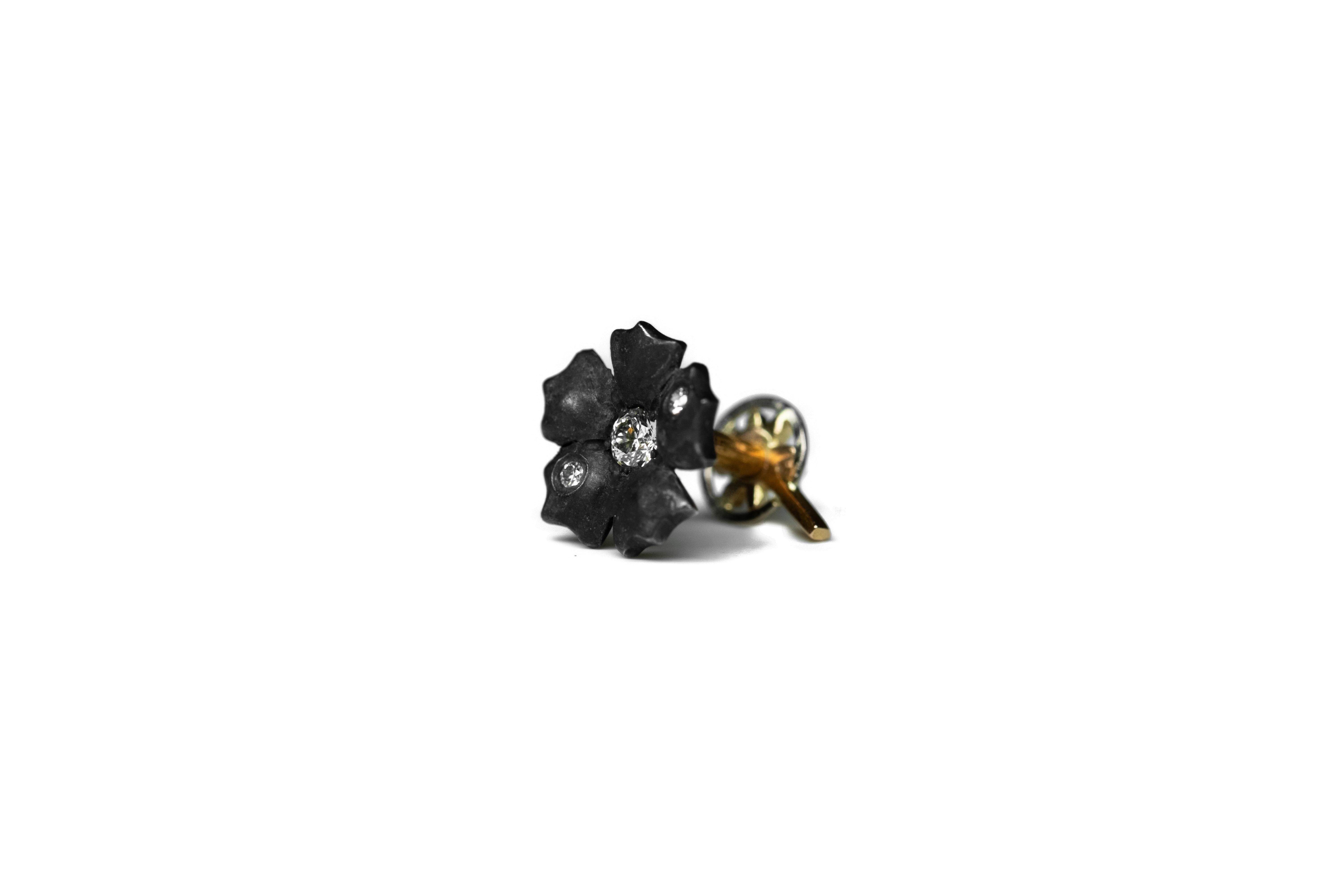 Flower-shaped ear piercing, completely handmade from 18K Fairmined yellow gold, oxidised Fairmined silver, and Canadamark diamonds.

The flower screws into the star at the back. The screw is handmade. We suggest closing it gently and being careful