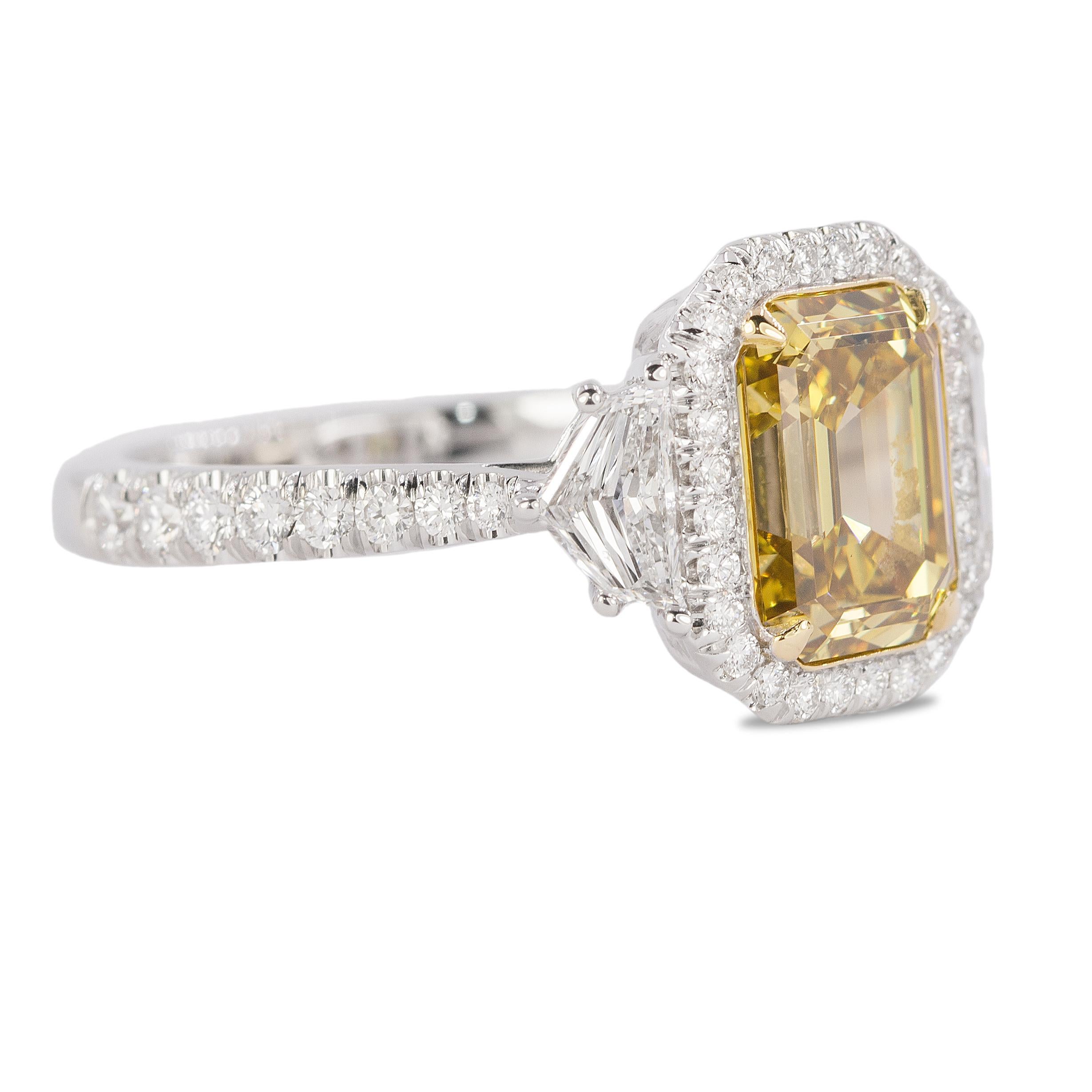 18kw ring with one GIA certified Fancy Deep Brownish Yellow VS2 clarity emerald cut diamond weighing 2.26 carats and two sheilds weighing 0.52 carats and 44 round diamonds weighing 0.56 carats, 5.25g