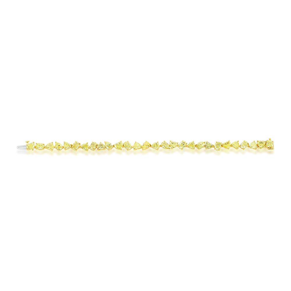 Fancy Intense Yellow diamonds set in 18K Yellow Gold. Each stone is GIA certified. The stones range from 0.50 Ct to 0.60 Ct. The bracelet is set with Hearts, Ovals, Pears, and one Cushion shaped diamond. The total carat weight of the bracelet is