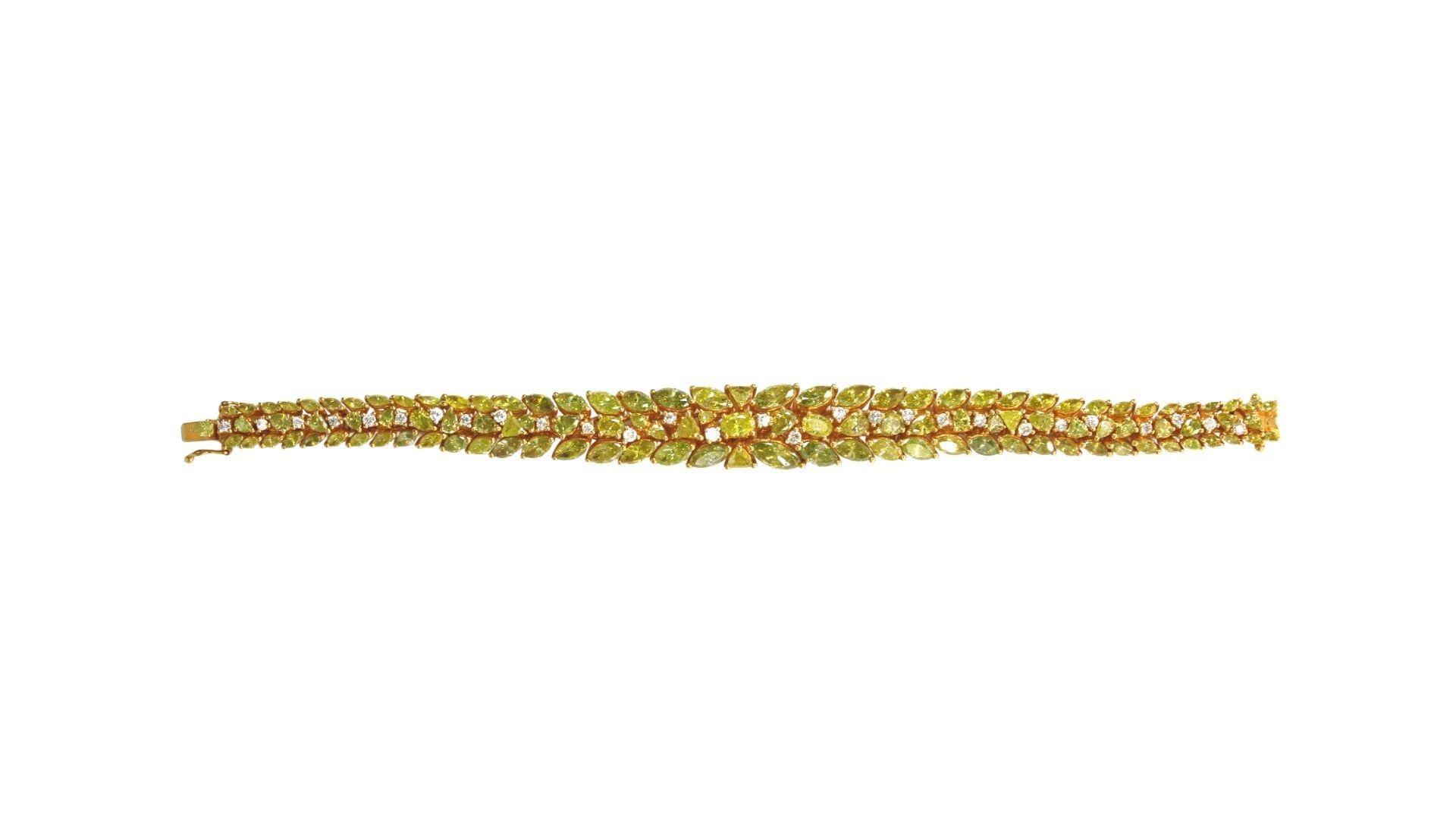 Diamond Leaf Bracelet in 18k Yellow Gold. 
Opposing laurel leaves stacked into a pattern of round yellow and white diamonds.
25.71.K Diamonds
*Signed*

Measures approx 7″ in length, 0.40″ in width

weight- 39.13 Grams.