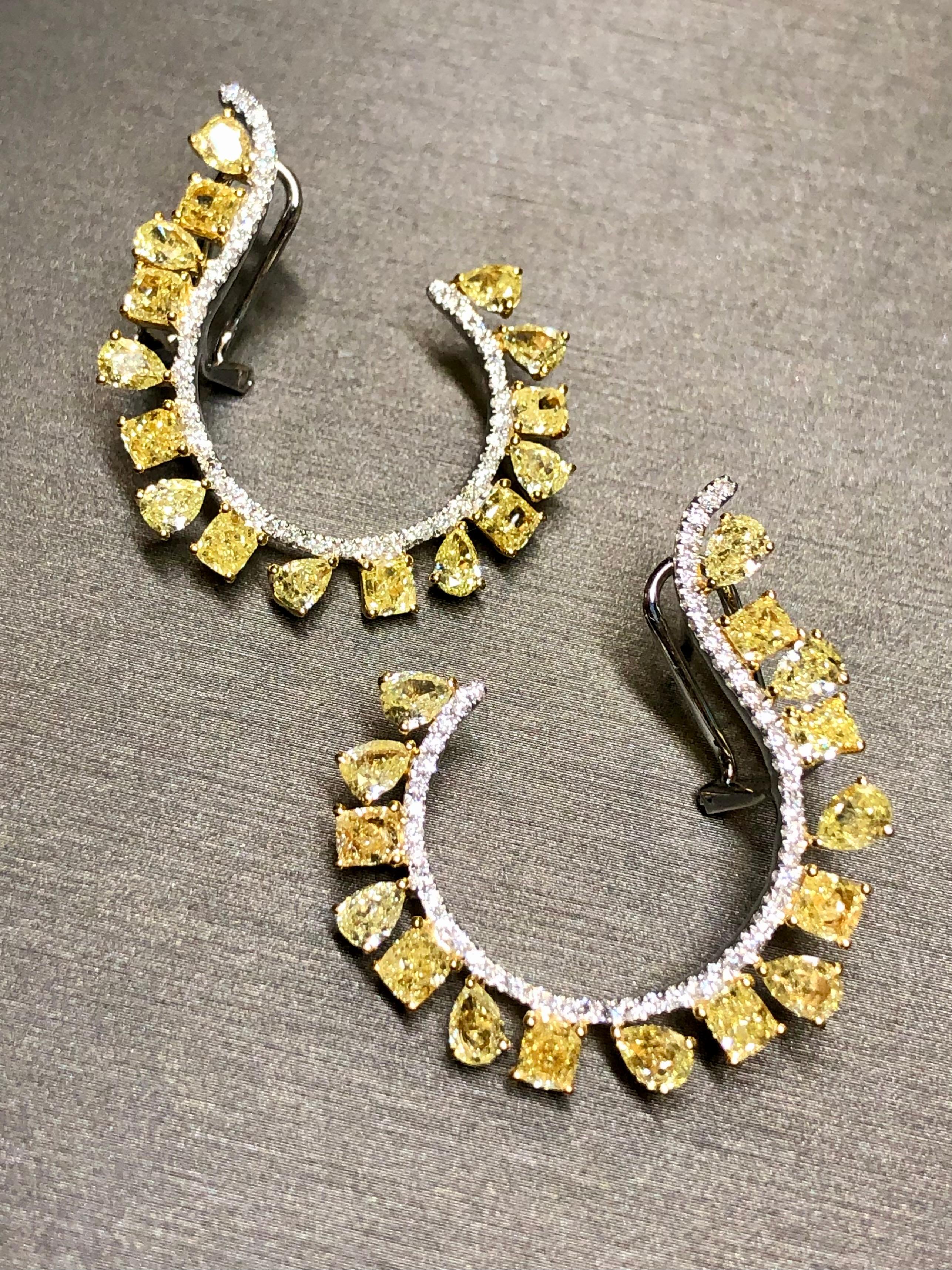 An absolutely spectacular pair of dramatic earrings crafted in 18k white and yellow, gold and prong set with natural fancy yellow pear shape and radiant cut diamonds totaling approximately 6.50cttw. All stones are fancy yellow and Si1-2 clarity.