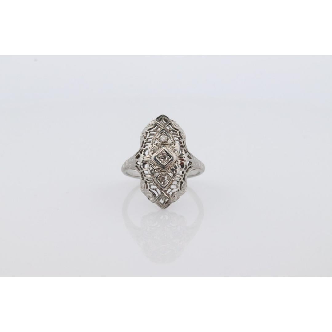 Vintage from the 1950s
Materials: Gold
Gemstone: Diamond
Gem color: Colorless
Band color: Gold
Style: Art deco
Very beautiful Art Deco diamond ring. Filigree open design shield with Three diamonds set in a white gold setting.

18k White Gold.