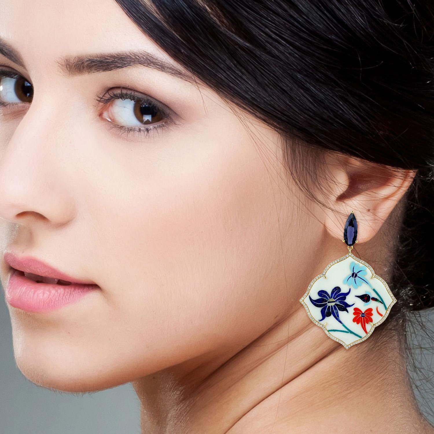 These intricate inlay earrings feature a unique hand painted floral miniature art set in 18K gold.  It is set with 4.11-carats Iolite, 32.38 carats Mother of Pearl and 1.14 carats of diamonds.

FOLLOW  MEGHNA JEWELS storefront to view the latest