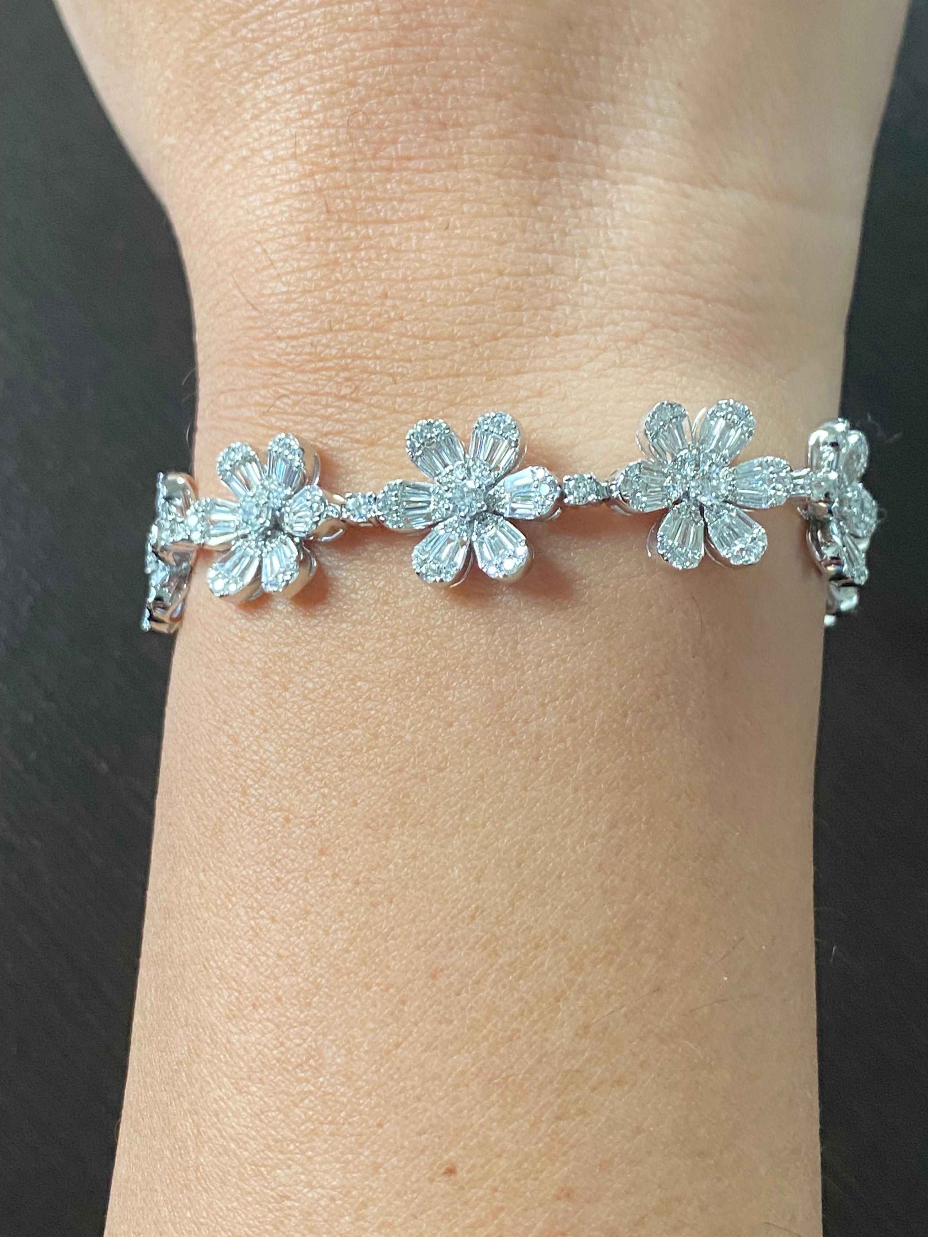 Flower daisy shaped bracelet set in 18K white gold. The bracelet is set with baguette and round diamonds. The total carat weight is 5.55. The color of the diamonds are F, the clarity is VS1.