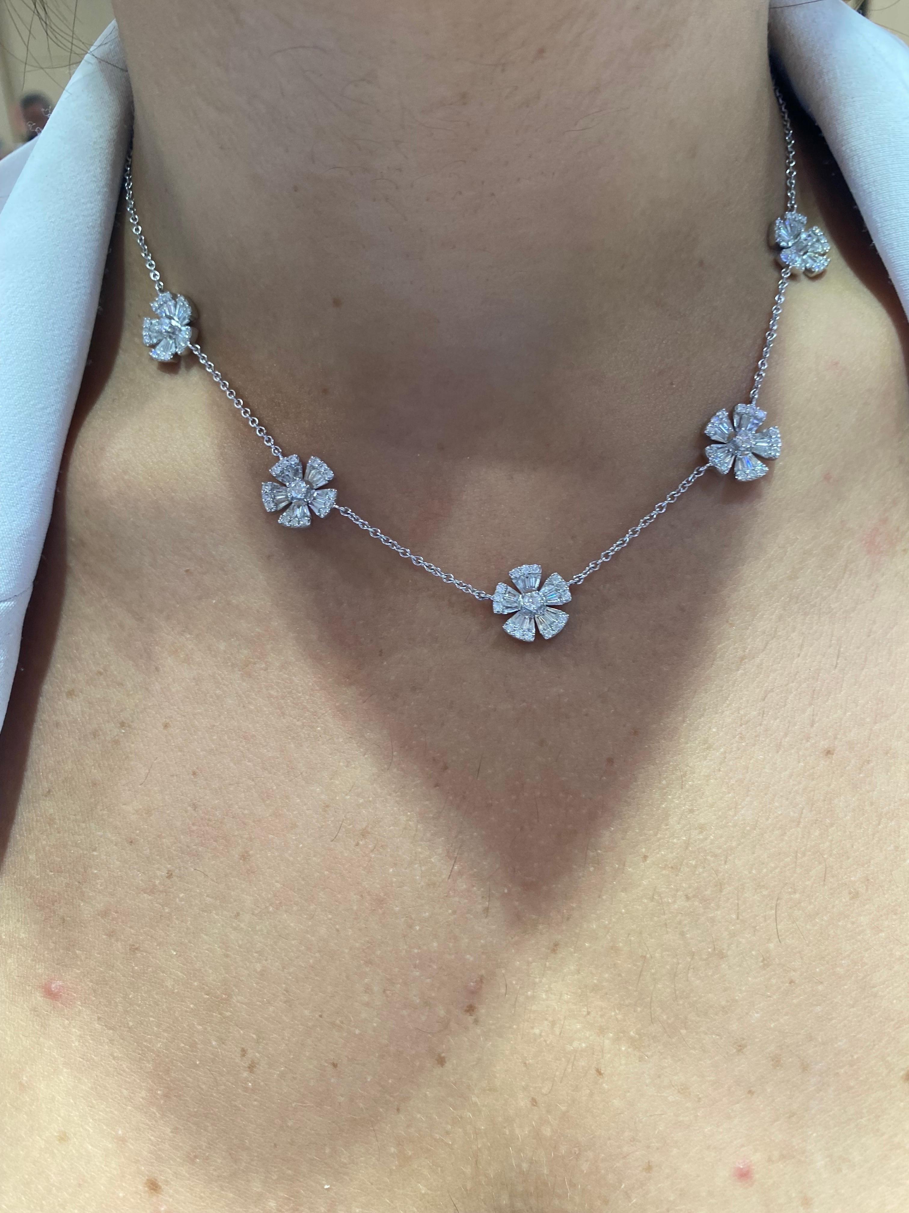 Diamond necklace set in 18K white gold. The necklace is set with 5 sections of baguette and round stones to create the illusion of a flower look. The total diamond weight of the piece is 2.62 carats. The color of the stones are F, the clarity is