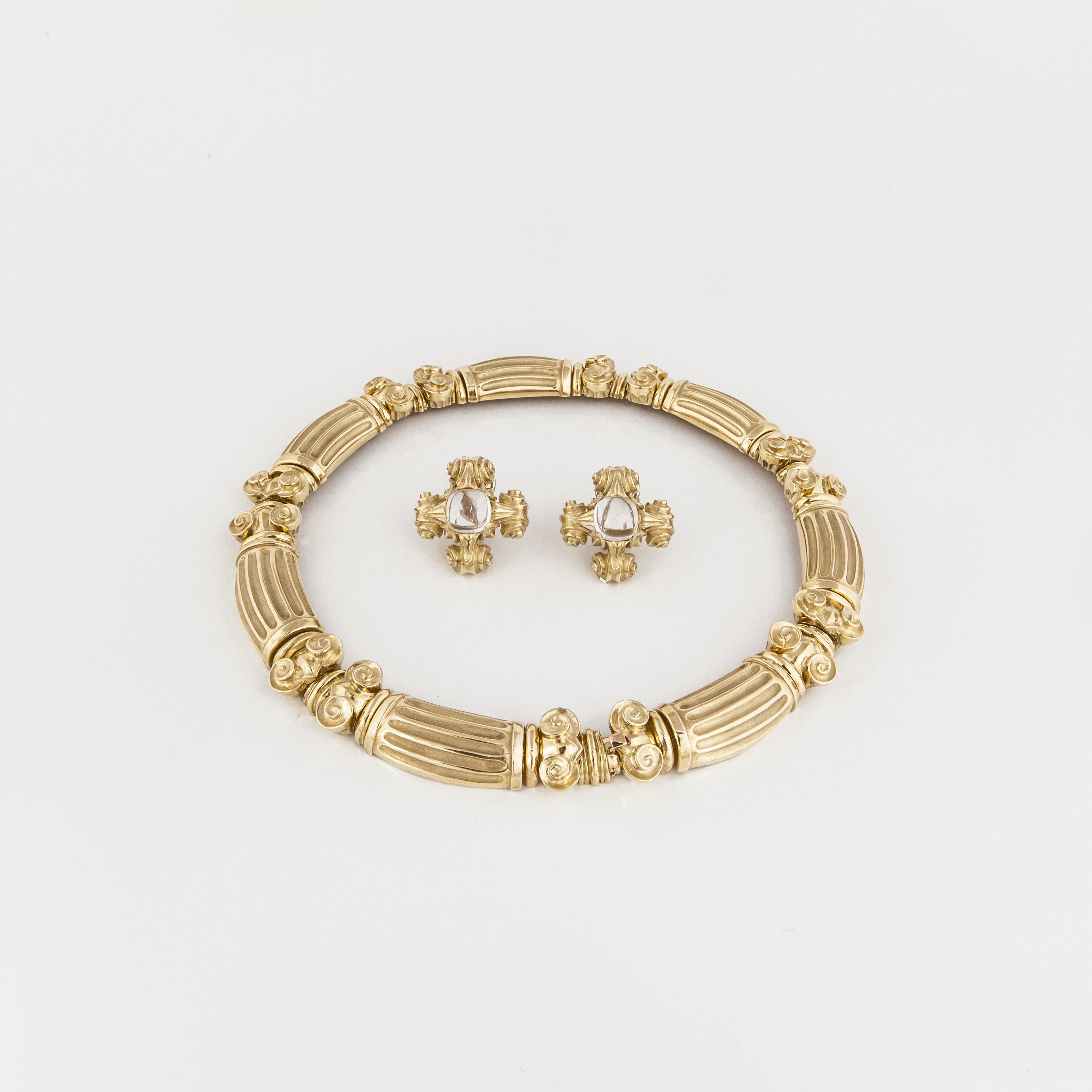 Esti Frederica jewelry suite in 18K yellow gold.  The choker necklace contains links that resemble columns with scrolling in between.  Necklace measures 15 1/2 inches long and 5/8 inches wide.  Tongue closure with underneath safety.  The earrings