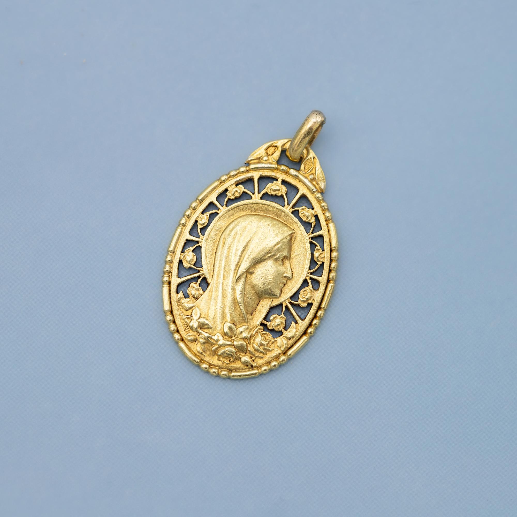 For sale is this stunning Art Deco mother Mary charm. This open-work charm depicts a veiled virgin Mary. Moreover an oval Stained glass like background is covered with a very detailled mother Mary who is looking up while the oval around her is