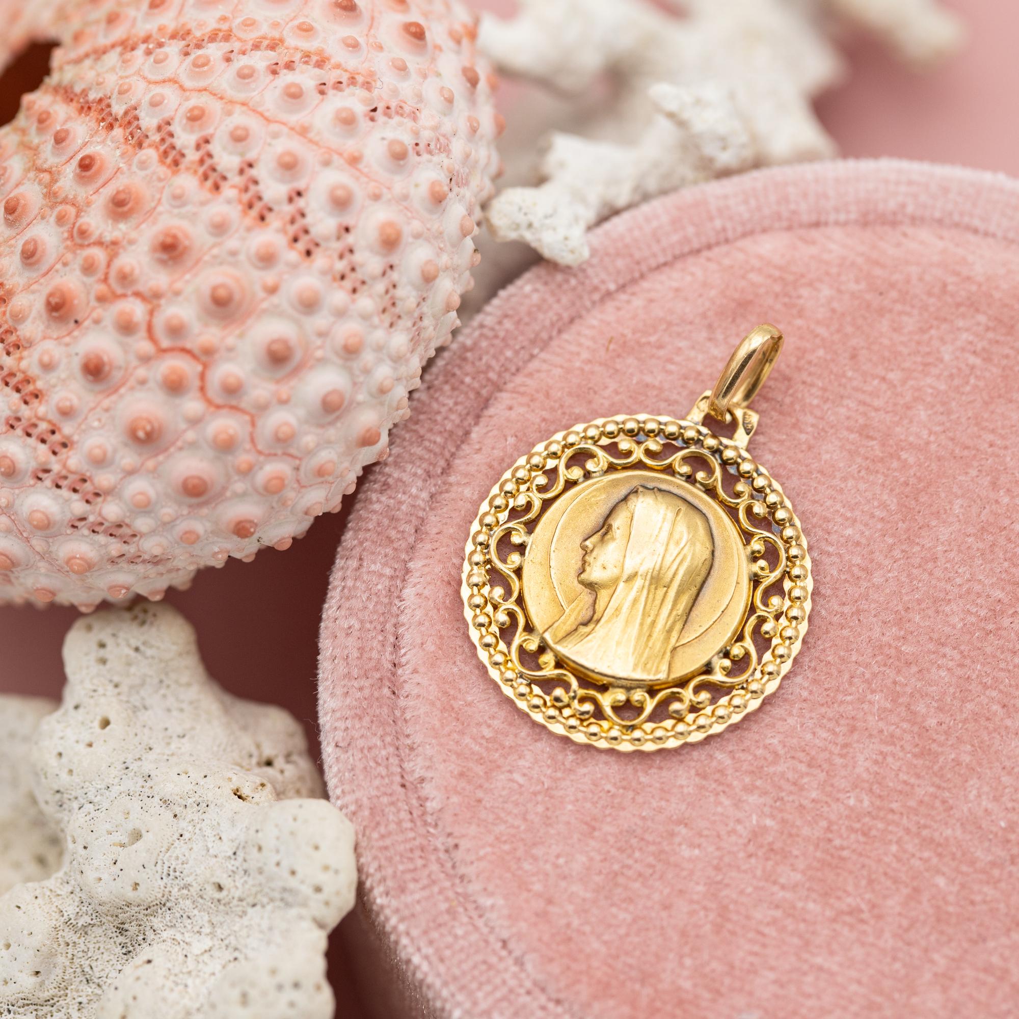 For sale is this Estate French mother Mary charm. This royal charm depicts a lovely virgin Mary. A raised bust of the Veiled Virgin Mary steals the show. This medallion is encircled with a big round of wonderful open work with a floral scroll