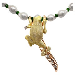 18K Frog Climbing on a 14K Leaf Hanging from a Necklace of Baroque Akoya Pearls