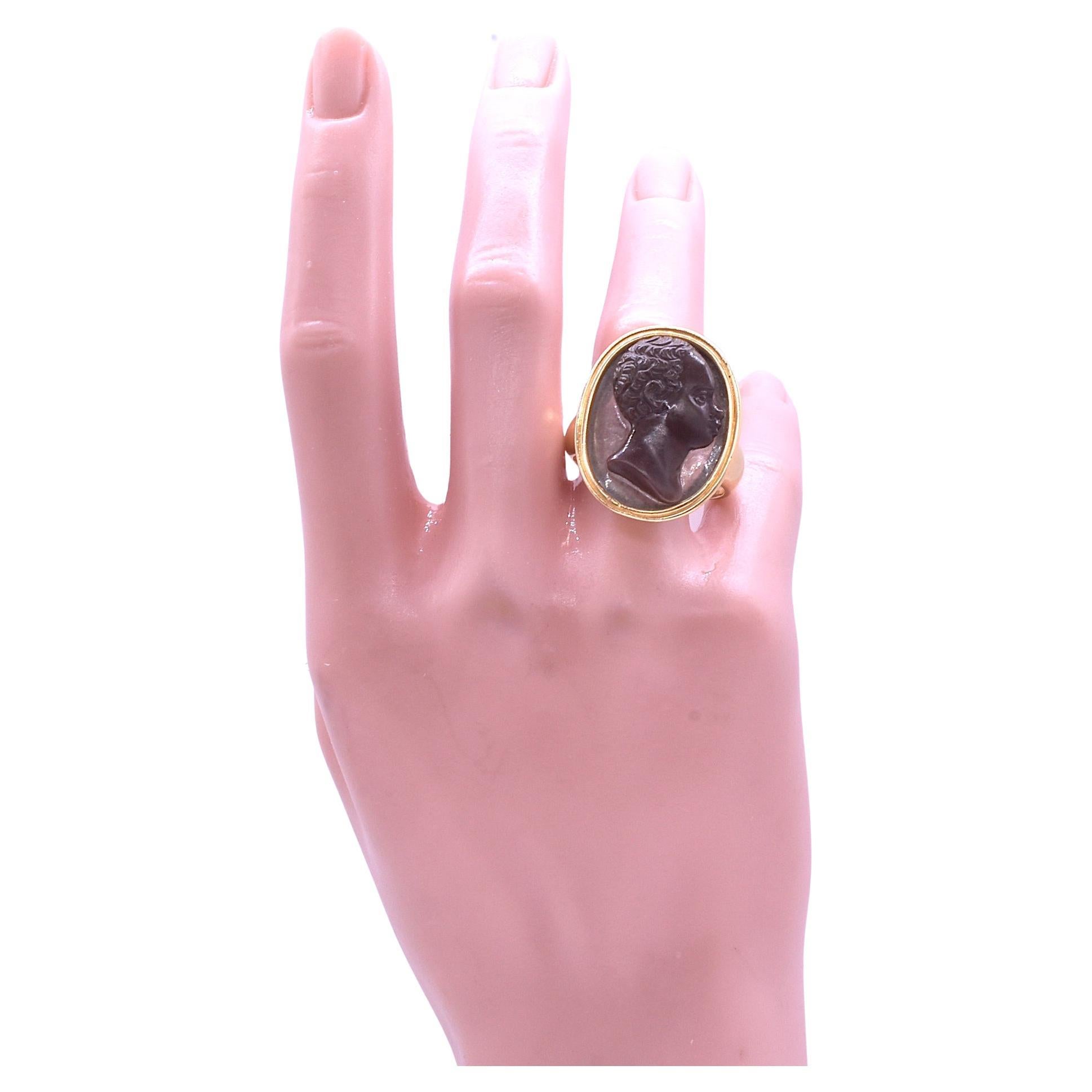 This is a spectacular, one of a kind,  cameo portrait signet ring collector's item made of sardonyx, a variety of banded onyx and a form of chalcedony quartz of reddish brown. Portrait cameos were often commissioned by those who had amassed enough