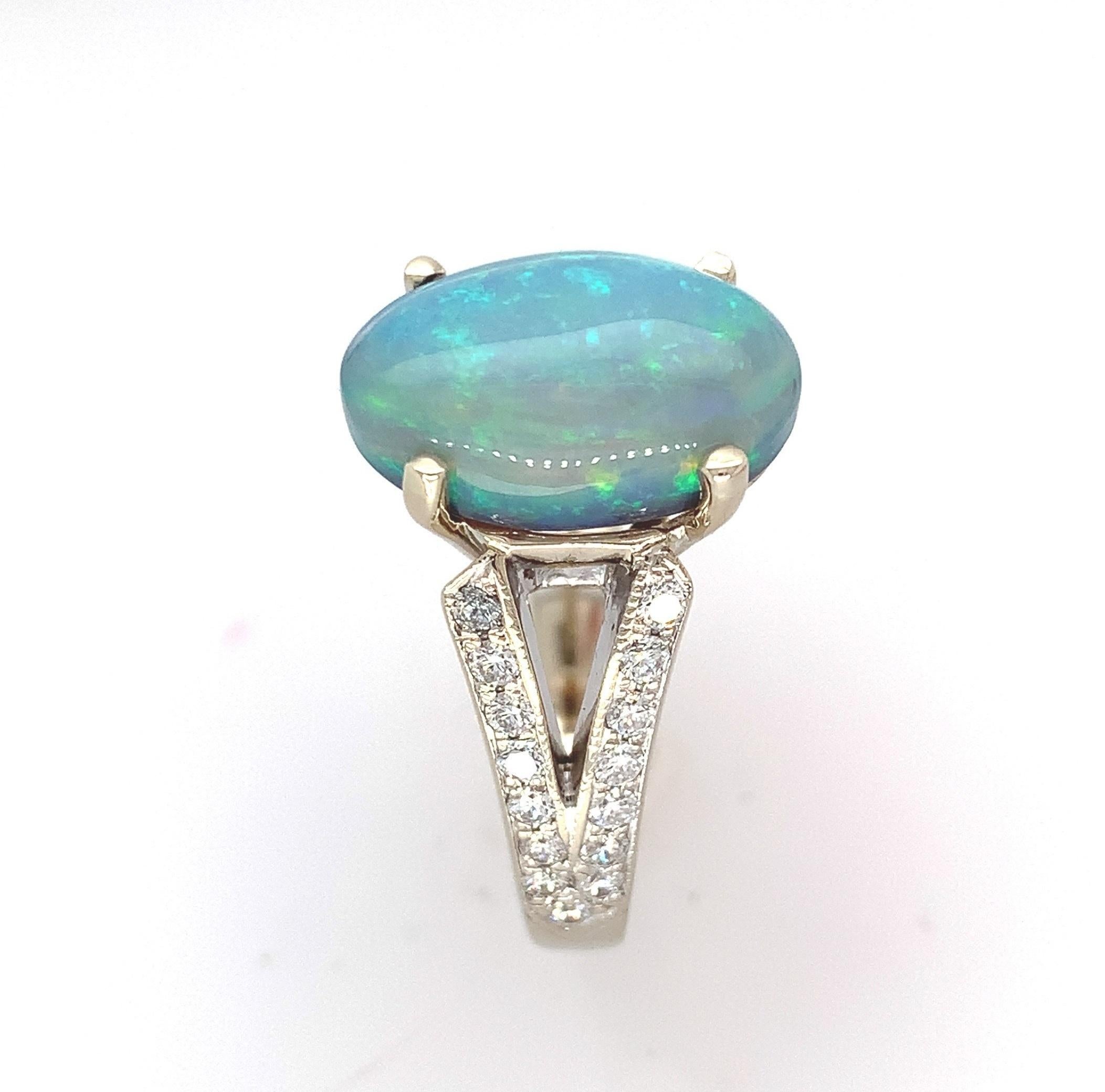 
18K white gold Australian black opal and diamond ring. There is a GIA report #2225667539 stating natural color opal weighing 4.39 carats and measuring 14.13mm x 9.31mm x 5.35mm. The opal has a grey body color with some black base and primarily