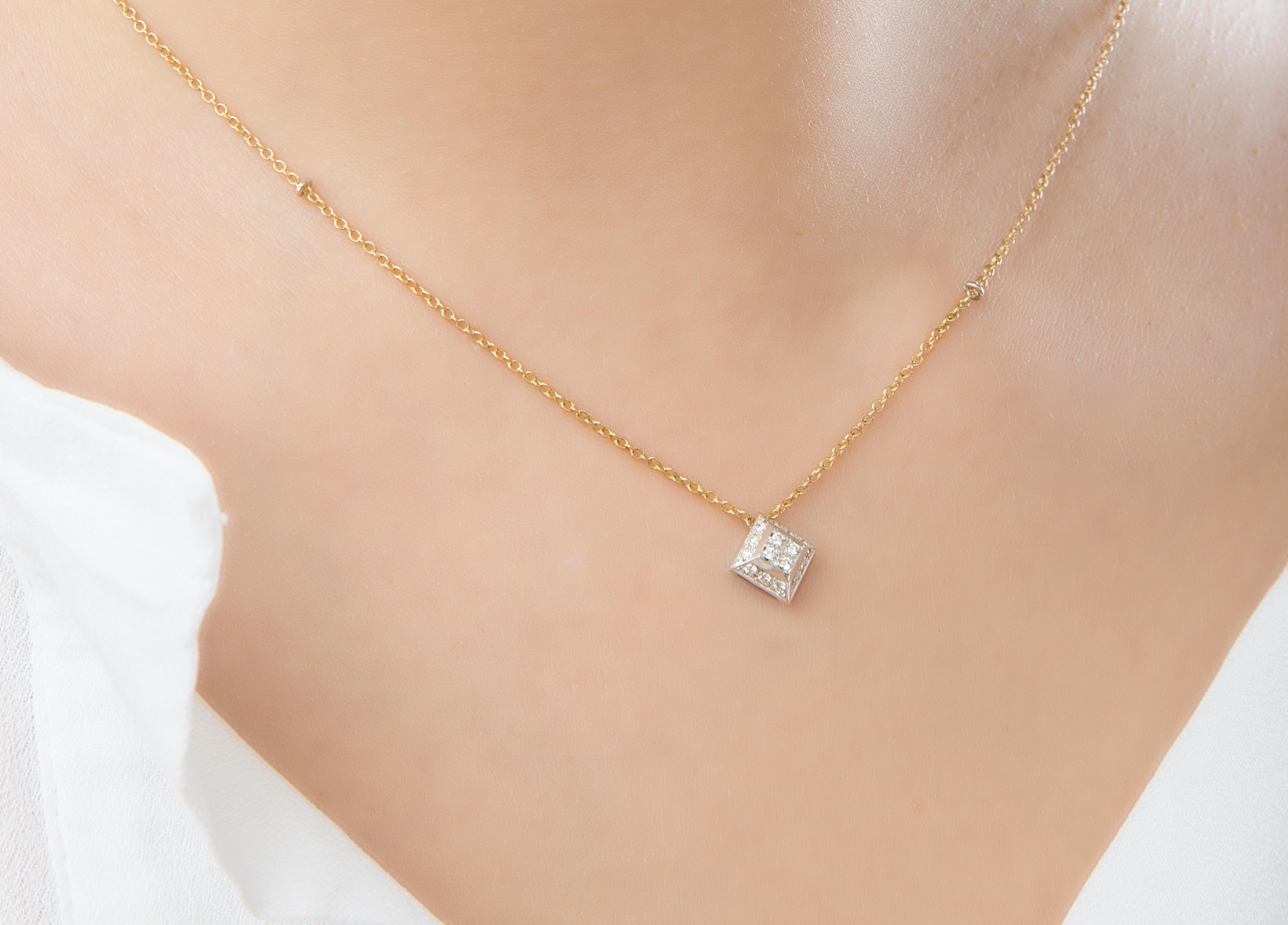 Rossella Ugolini Design Collection, 18 Karats Yellow Gold chain and 18k White Gold pendant enriched with 0.20 carats White Diamonds.
This Modern Necklace feature a square pyramid pendant adorned with 0.20 dazzling White Diamonds making a true