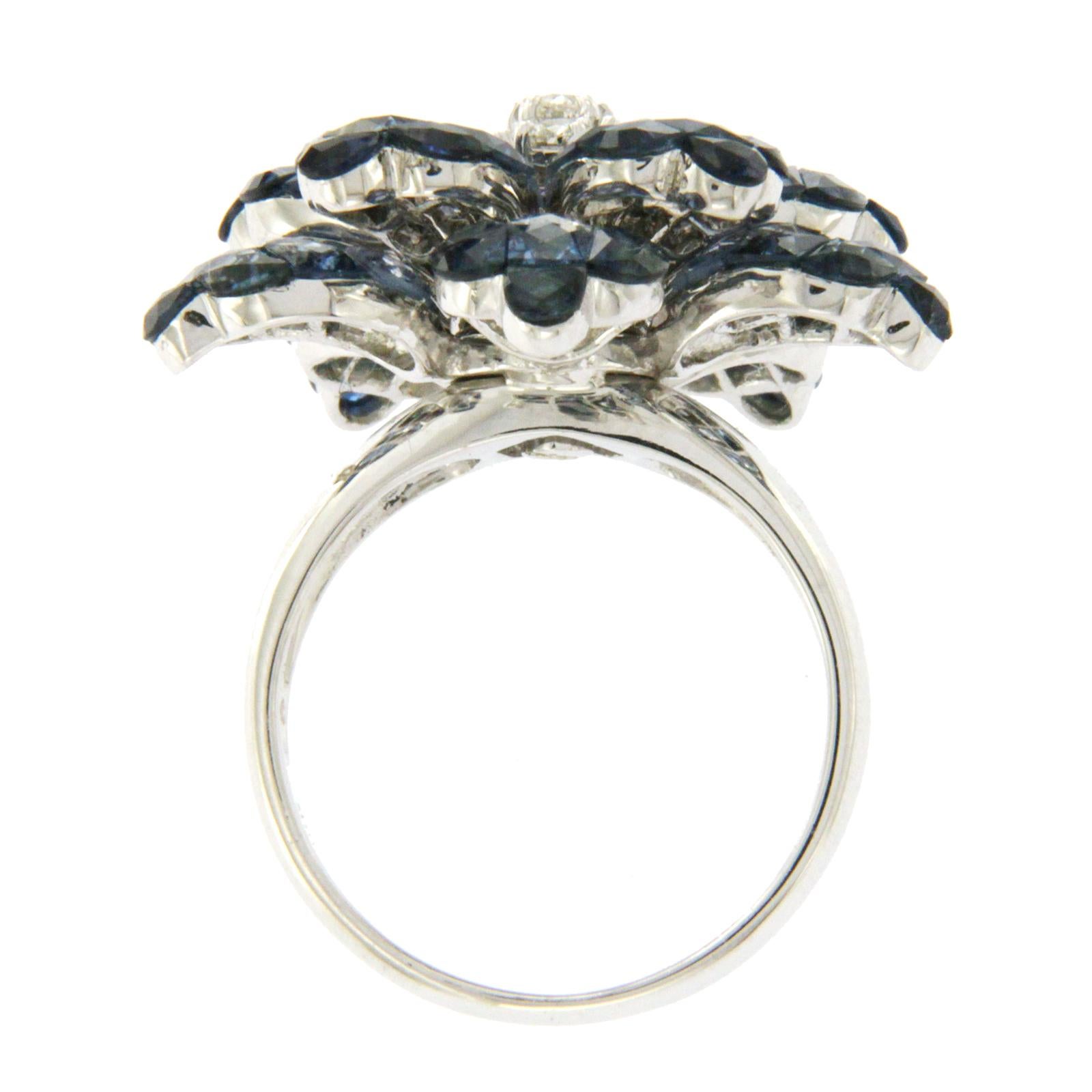 Top: 26 mm
Band Width: 3 mm
Metal: 18K White Gold
Size: 6.5
Hallmarks: 18K
Total Weight: 12.8 Grams
Stone Type: 0.37 Ct Diamonds VS2 G-F & 13.90 CT Natural Blue Sapphire
Condition: New
Stock Number: R2574
Estimated Retail Price: $13999

Please
