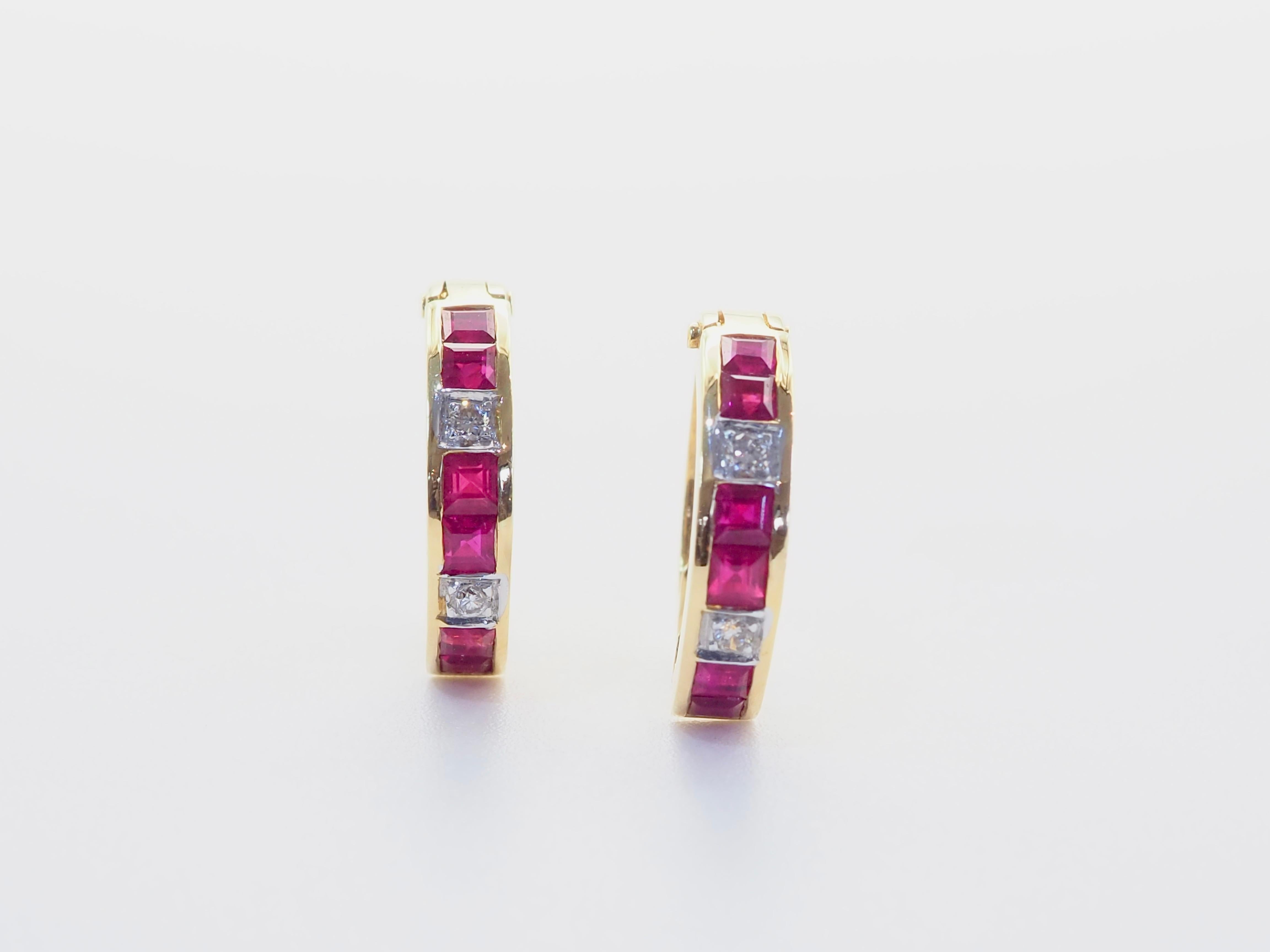 A striking pair of hoop stud earrings crafted in rich 18 karat yellow gold, featuring a vertical arrangement of squared rubies totaling approximately 0.90 carats. Each of two vivid red stones are framed by delicate 0.04 carat diamond accents, adding