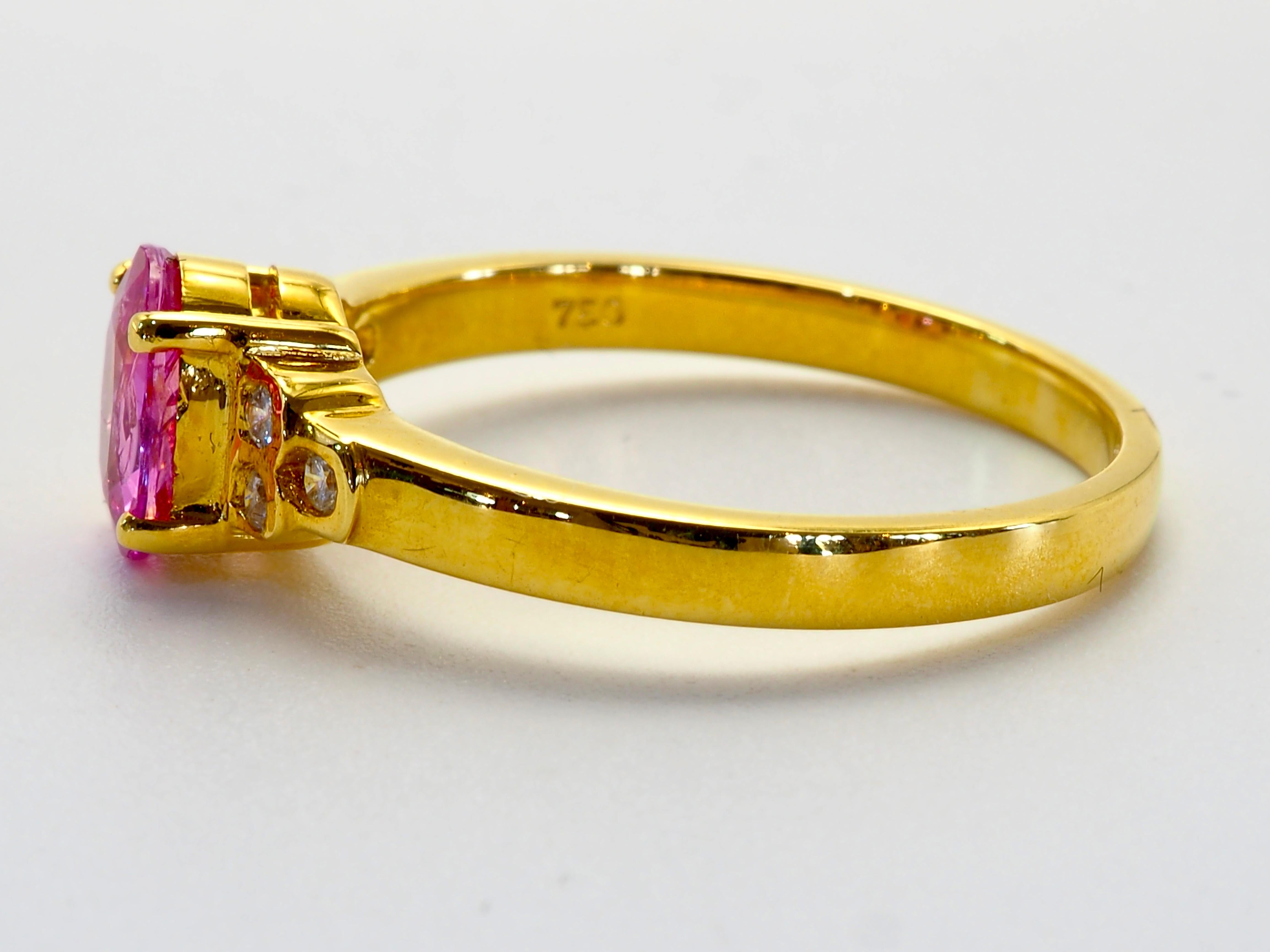 Fine classic and precious engagement ring in 18k solid yellow gold. The main gemstone is the rare and prized pink colored oval sapphire, almost flawless with some minor white lines visible across face. The color is highly saturated pink and very
