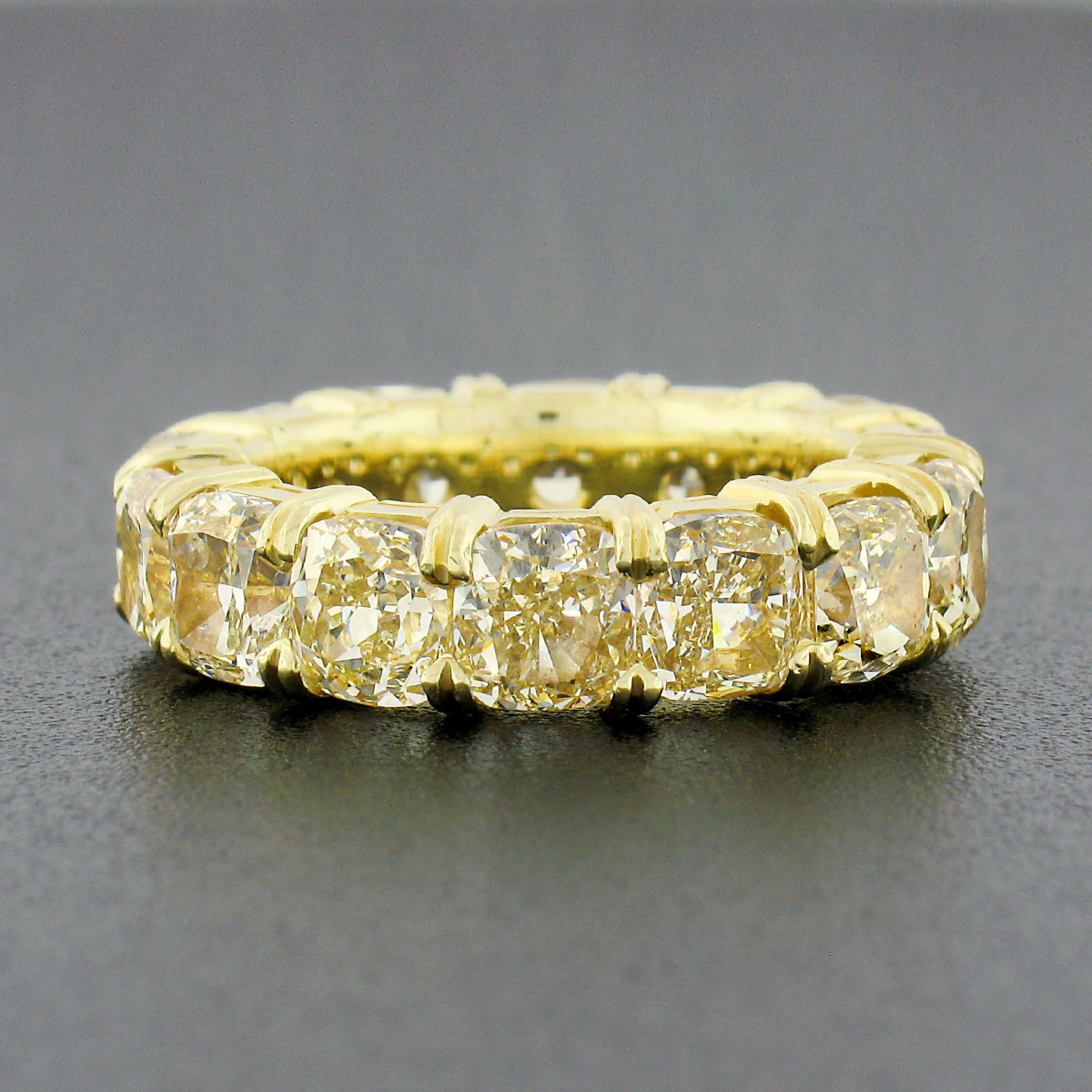 This spectacular diamond eternity band ring is crafted from solid 18k yellow gold and features a set of 14 large and fiery cushion cut yellow diamonds which of two have been certified by GIA and come accompanied with the certifications for these 2