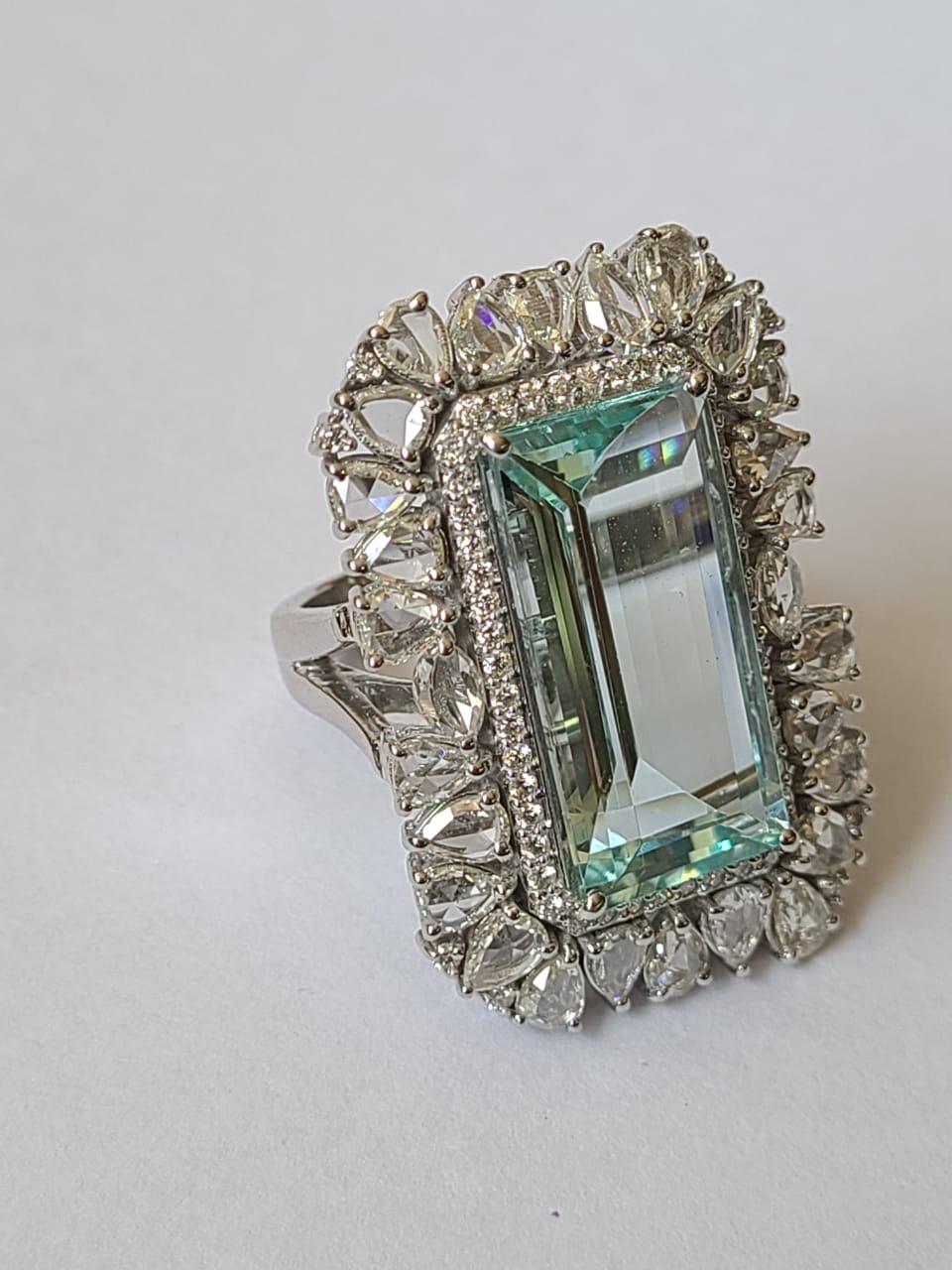 A very gorgeous Aquamarine Cocktail Ring set in 18K Gold & Diamonds. The Aquamarine, weighing 10.11 carats, is completely natural, without any treatment. The combined weight of the Diamonds is 3.03 carats. Net gold weight is 13.32 grams. The