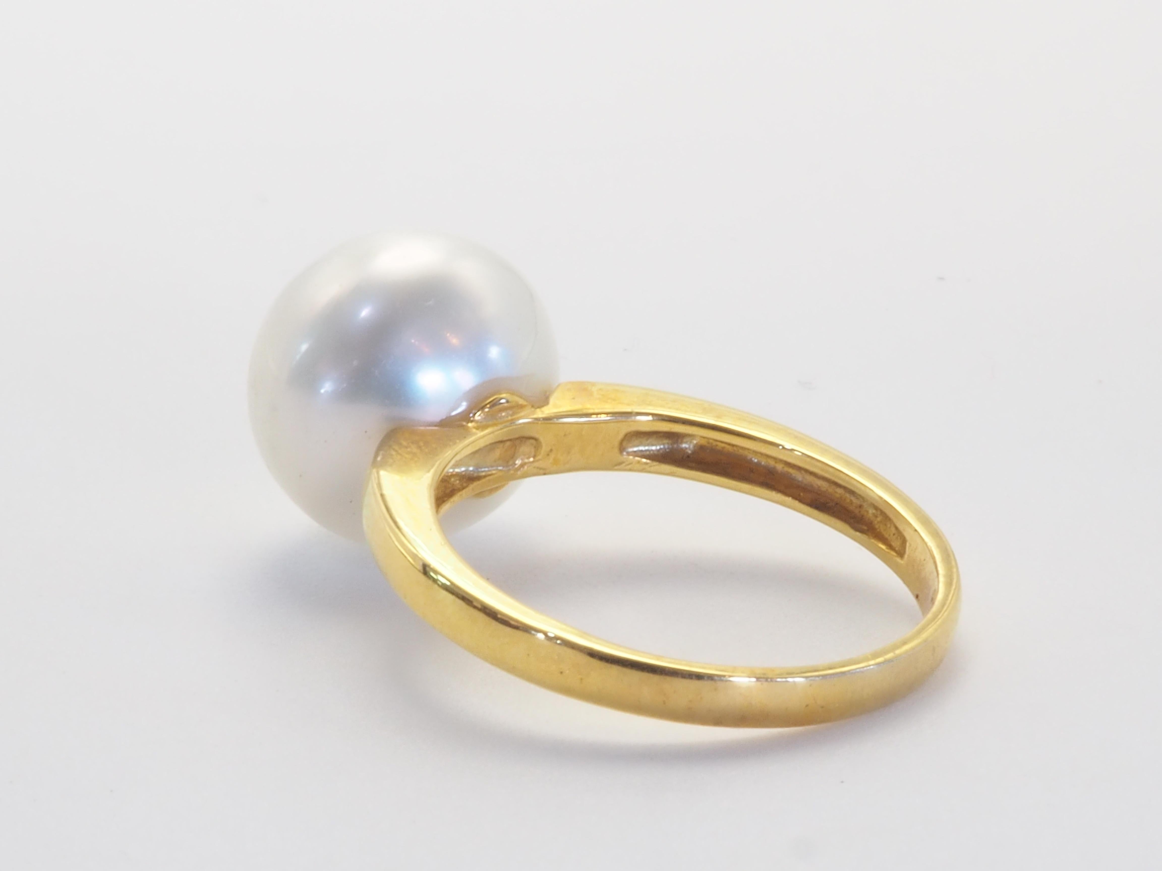 This brilliant 18k gold ring is adorned with a rare and beautiful South Sea pearl! The pearl is almost round and has little visible blemishes. The diameter of the pearl is around 11 mm! The pearl is famous for being a June birthstone. This elegantly