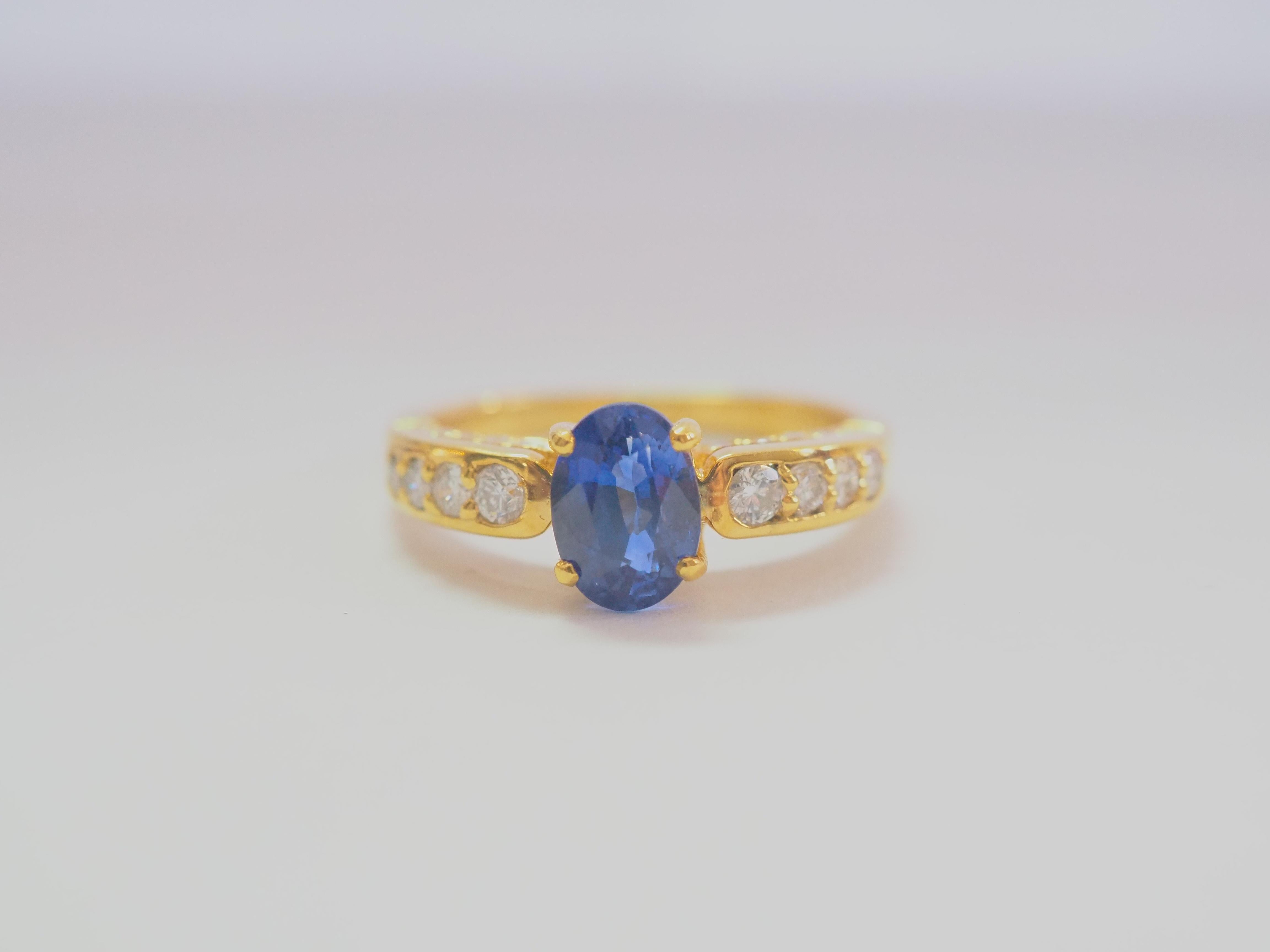 This beautiful engagement ring boasts a very stunning and almost eye clean blue sapphire! The sapphire is an oval cut and is very clear with good saturation of well sought after cornflower blue color. There are 8 bigger round brilliant diamonds